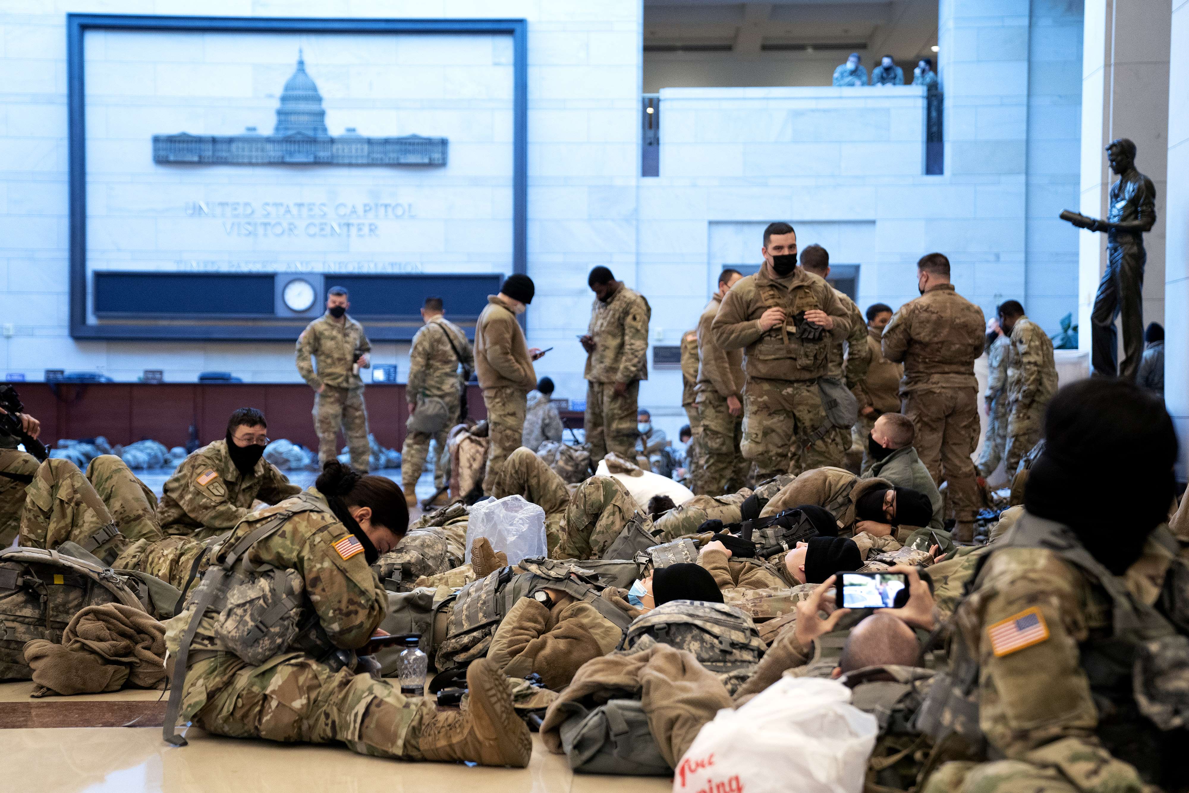 WASHINGTON, DC - JANUARY 13: Members of the National Guard rest in the Visitor Center of the U.S. Capitol on January 13, 2021 in Washington, DC. Security has been increased throughout Washington following the breach of the U.S. Capitol last Wednesday, and leading up to the Presidential inauguration. Stefani Reynolds/Getty Images/AFP
== FOR NEWSPAPERS, INTERNET, TELCOS & TELEVISION USE ONLY ==