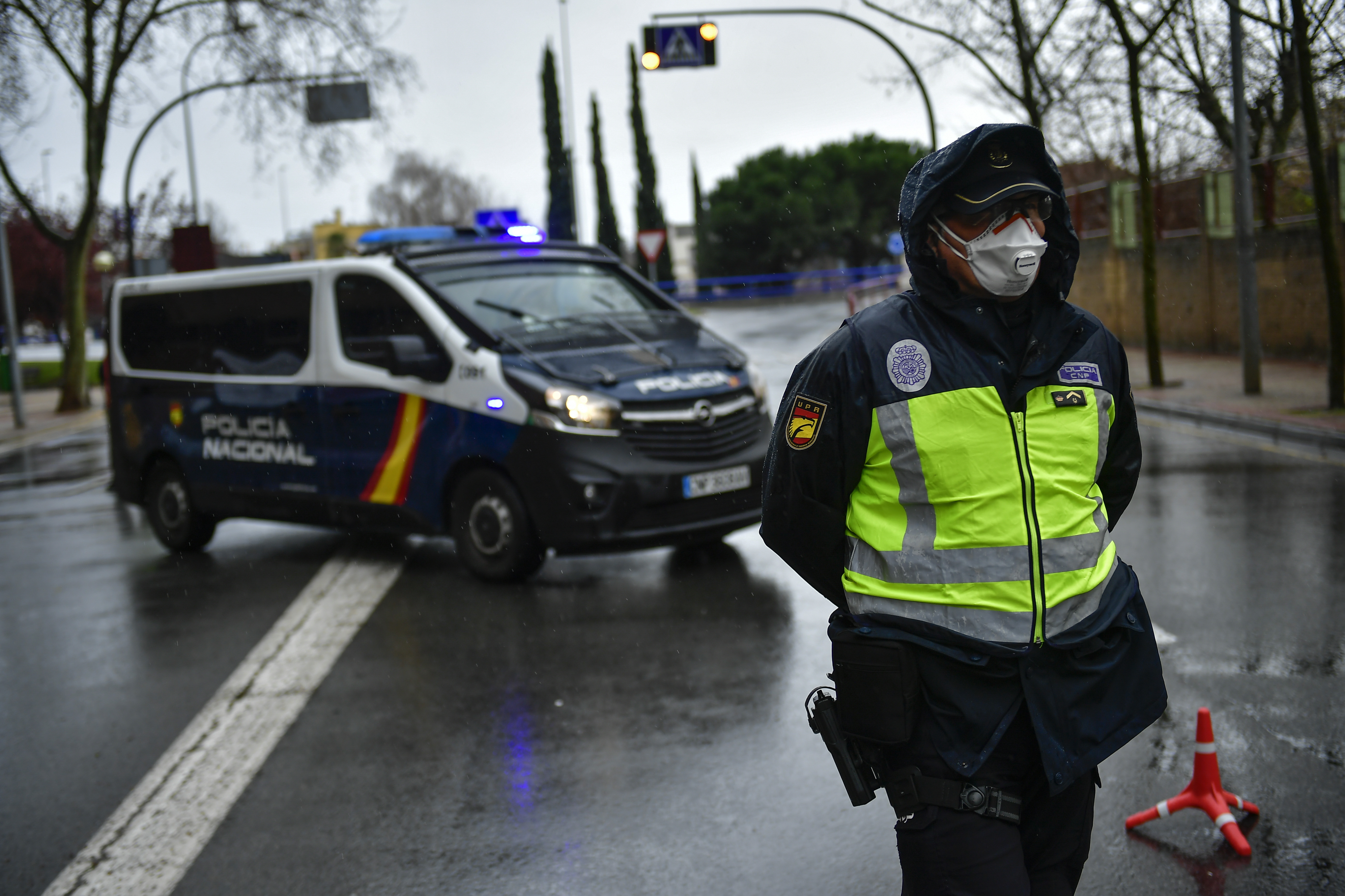 Spanish police controls the access to Logrono, northern Spain, Monday, March 16, 2020. After deploying the army to the streets and to clean train stations, ordering 46 million to stay at home and taking over control of private hospitals, the Spanish government is considering now closing the country's borders to halt the spread of the coronavirus. For most people, the new coronavirus causes only mild or moderate symptoms. For some, it can cause more severe illness, especially in older adults and people with existing health problems. (AP Photo/Alvaro Barrientos)