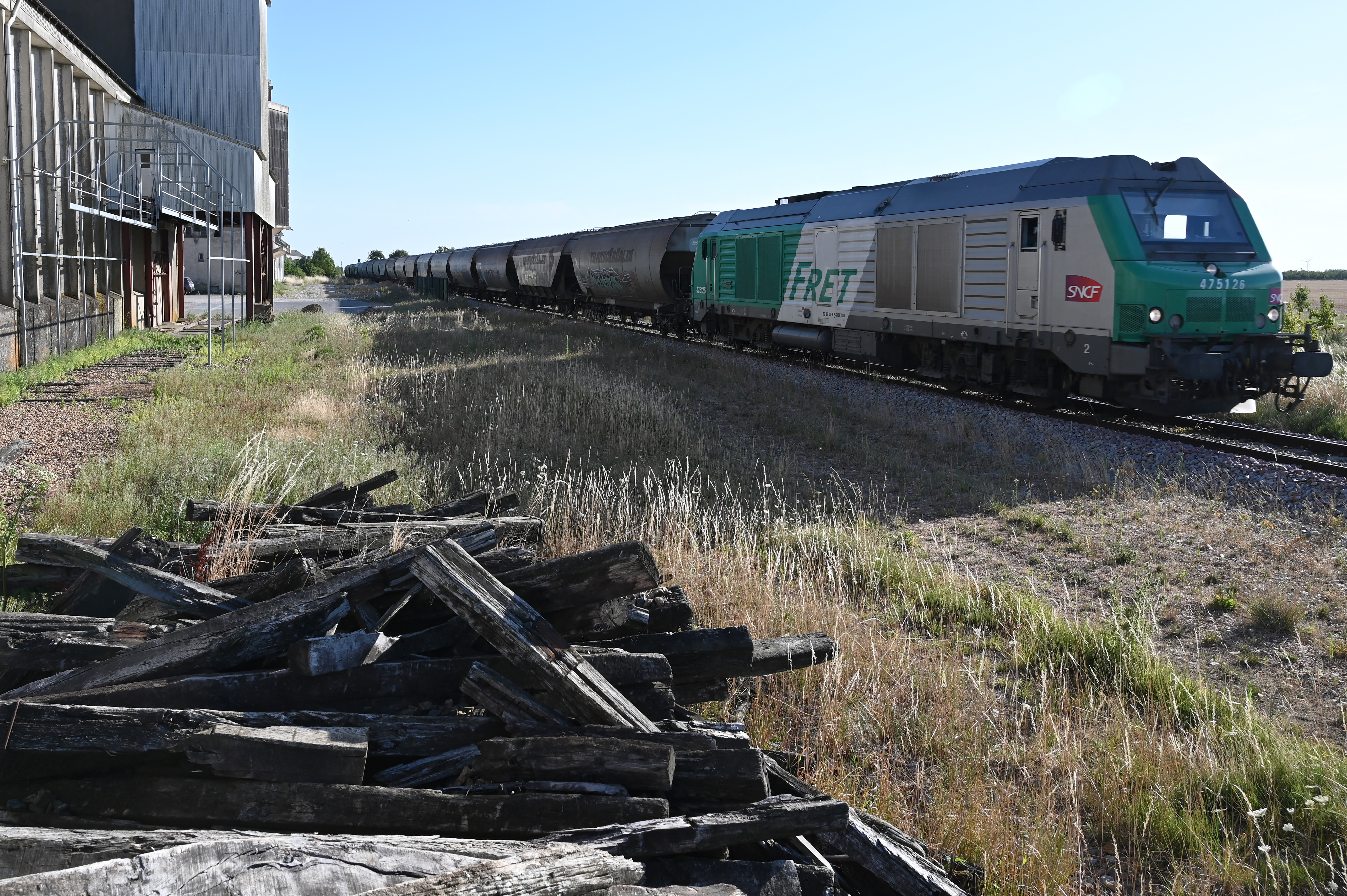 In this photograph taken on July 15, 2022, a SNCF train freight transporting cereals passes on the Coutalain-Chartres railway line next to the sleepers of the old track, in Bailleau-Le-Pin, northwestern France. (Photo by Jean-Fran�ois MONIER / AFP)