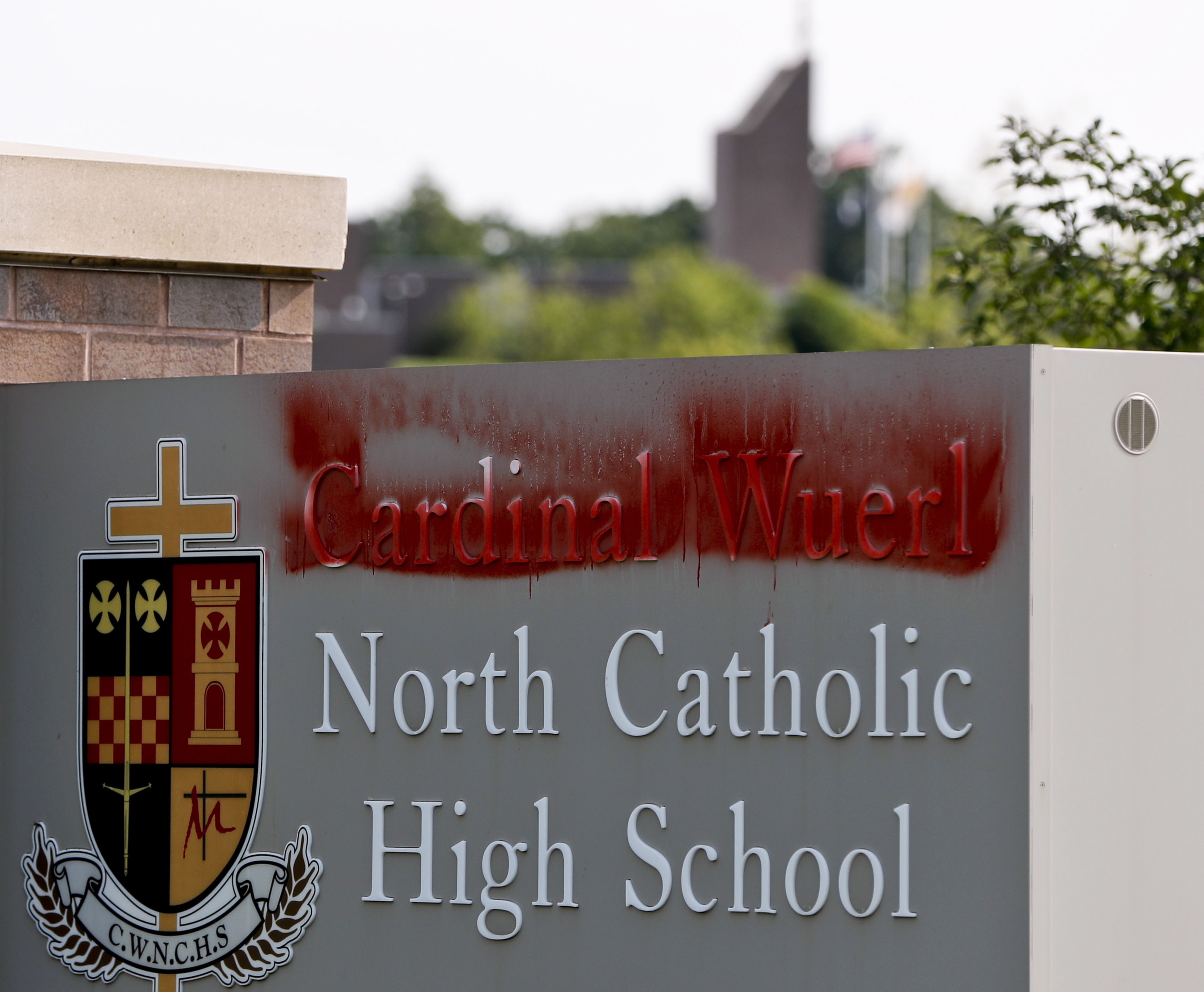 Paint covers the name of Cardinal Wuerl at Cardinal Wuerl North Catholic High School, on Monday, Aug. 20, 2018, in Cranberry Township, Pa. Wuerl, a Roman Catholic Cardinal, and the archbishop of Washington, D.C., has come under fire from revelations in the Pennsylvania grand jury report about his actions while bishop of Pittsburgh. (AP Photo/Keith Srakocic)