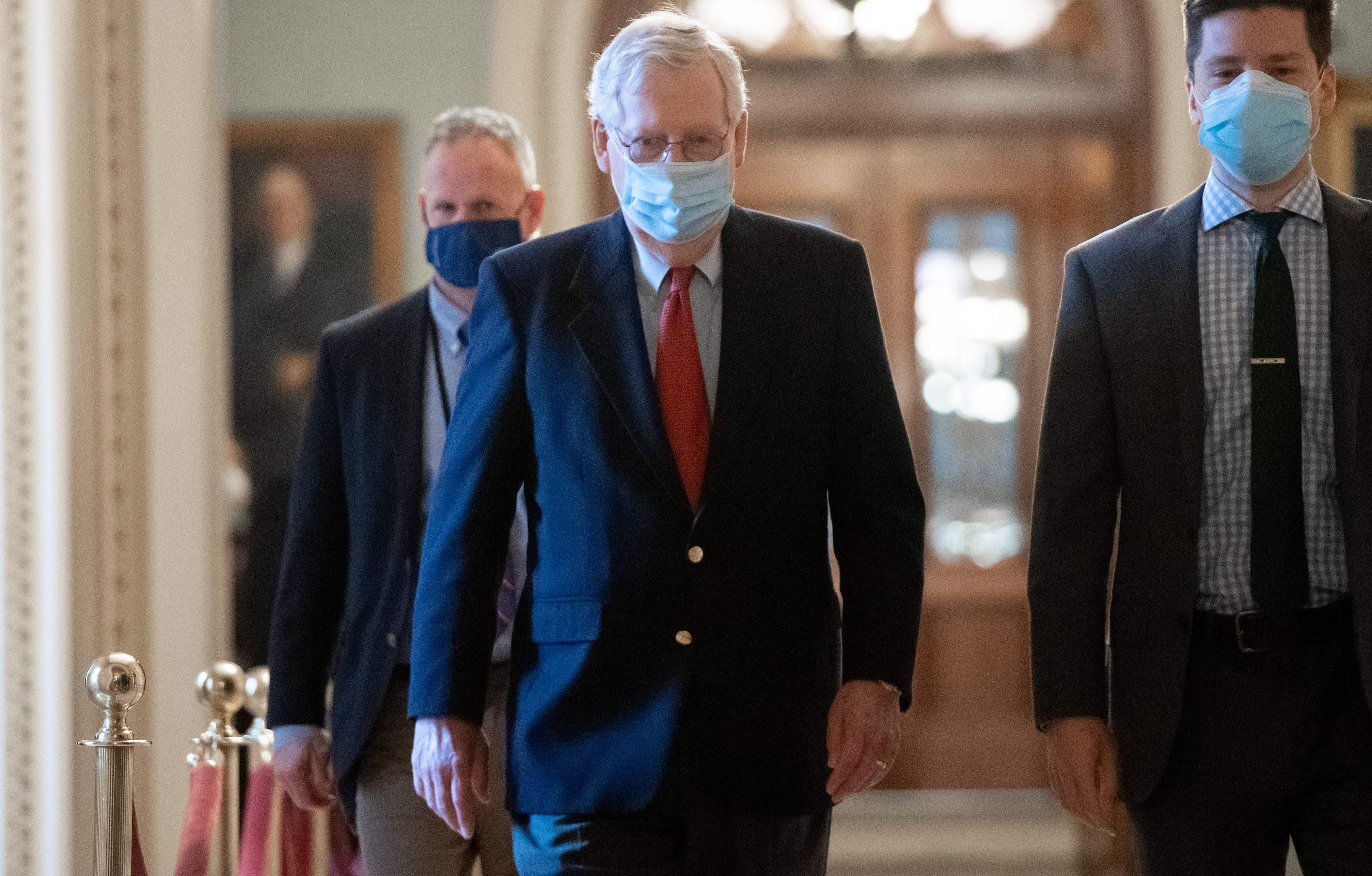 (FILES) In this file photo taken on December 18, 2020 US Senate Majority Leader Mitch McConnell, Republican of Kentucky, walks to his office from the Senate Floor at the US Capitol in Washington, DC. - US lawmakers on December 21, 2020 approved a $900 billion relief package that will provide a long-sought boost for millions of Americans and businesses battered by the coronavirus pandemic. (Photo by SAUL LOEB / AFP)