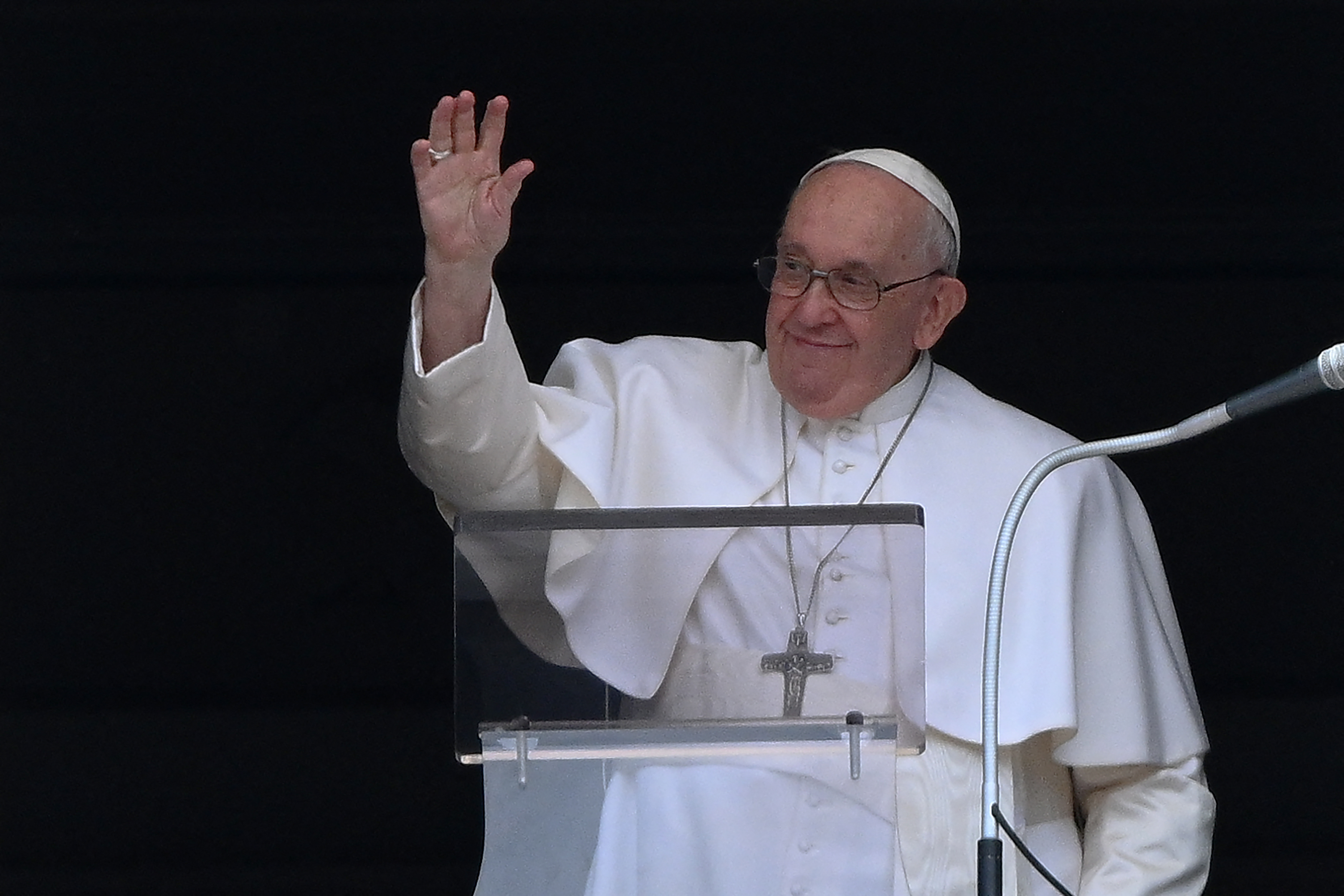 Pope Francis waves as he prepares to deliver his Regina Coeli prayer from a window overlooking St. Peter's square on April 23, 2023. (Photo by Vincenzo PINTO / AFP)