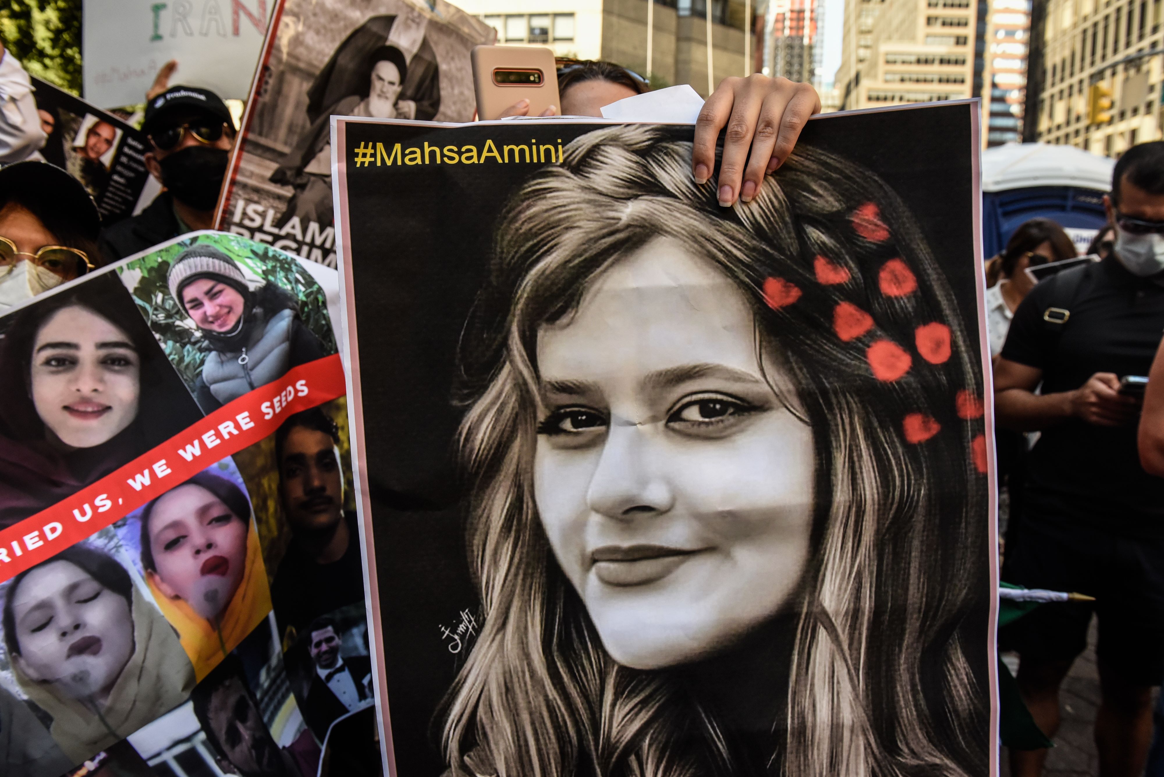 NEW YORK, NY - SEPTEMBER 21: People participate in a protest against Iranian President Ebrahim Raisi outside of the United Nations on September 21, 2022 in New York City. Protests have broke out over the death of 22-year-old Iranian woman Mahsa Amini, who died in police custody for allegedly violating the country's hijab rules. Amini's death has sparked protests across Iran and other countries. Stephanie Keith/Getty Images/AFP