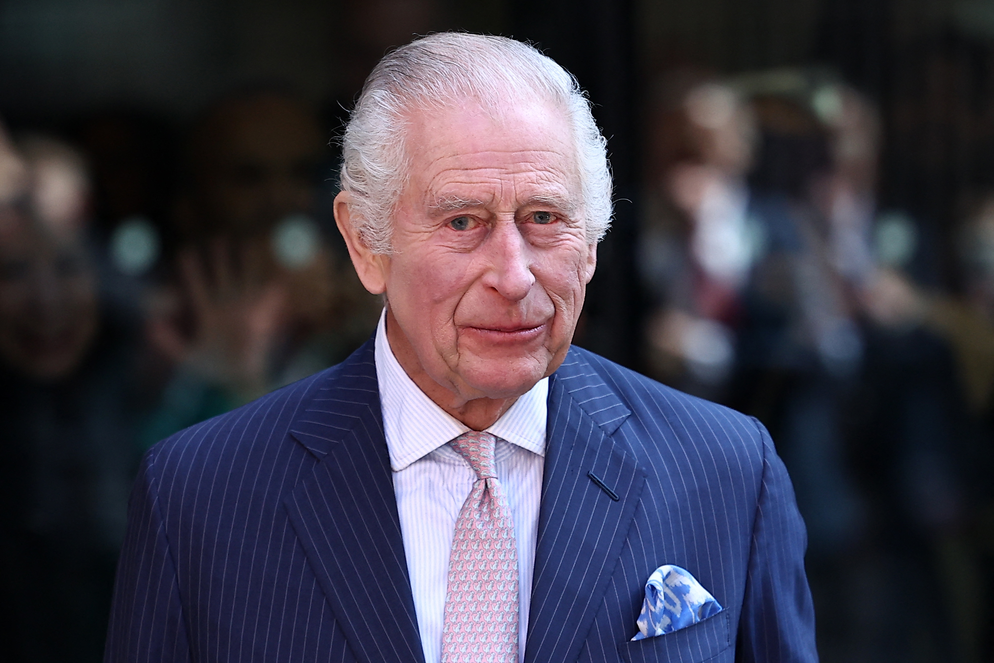 Britain's King Charles III and Britain's Queen Camilla recieve a bouquet of flowers after a visit to the University College Hospital Macmillan Cancer Centre in London on April 30, 2024. Charles is making his first official public appearance since being diagnosed with cancer, after doctors said they were "very encouraged" by the progress of his treatment. (Photo by HENRY NICHOLLS / AFP)