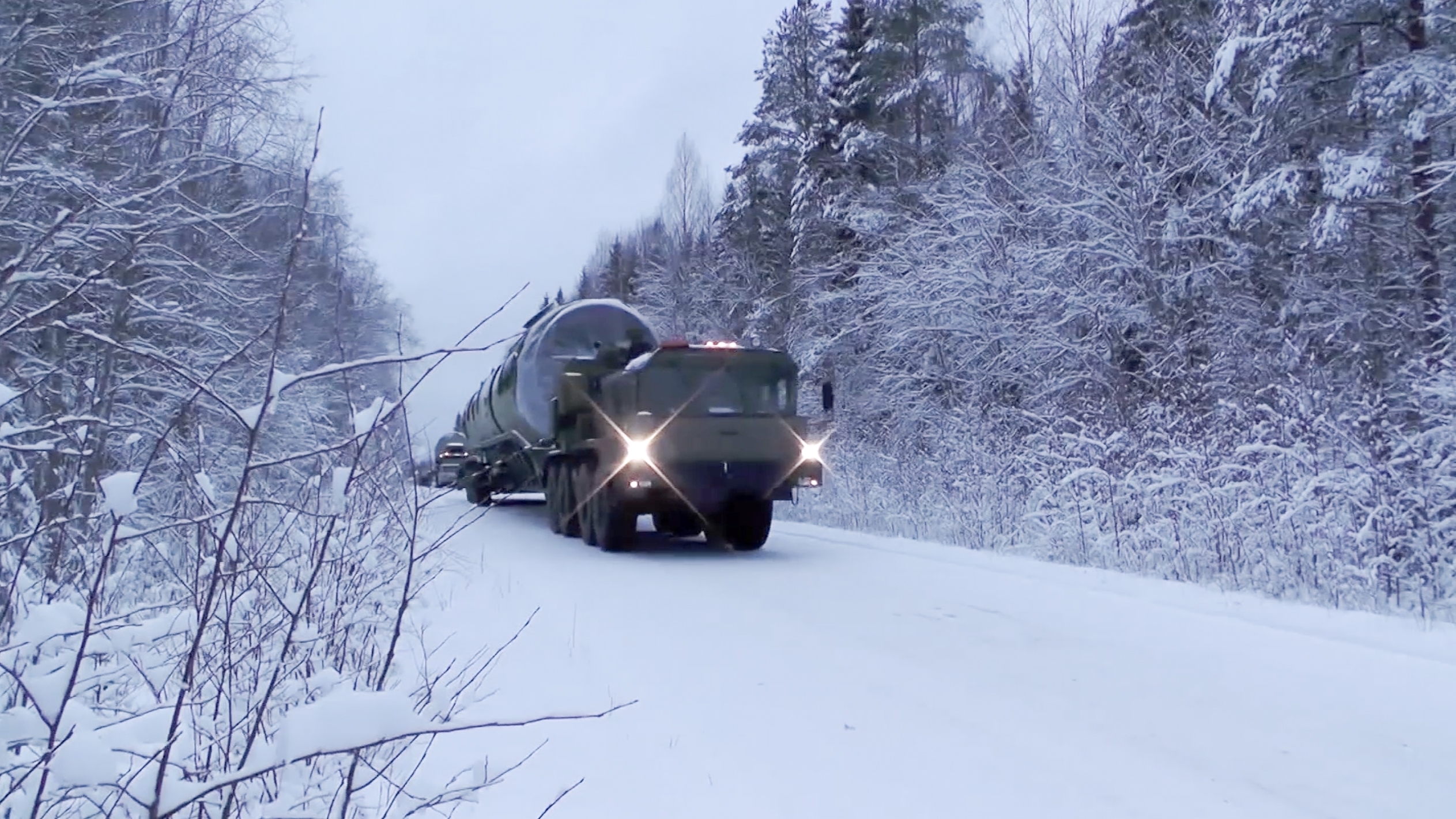In this video grab provided by RU-RTR Russian television via AP television on Thursday, March 1, 2018 , a truck carrying Russia's new Sarmat intercontinental ballistic missile drives through a forest at an undisclosed location in Russia. President Vladimir Putin declared Thursday that Russia has developed a range of new nuclear weapons, claiming they can't be intercepted by enemy. (RU-RTR Russian Television via AP)