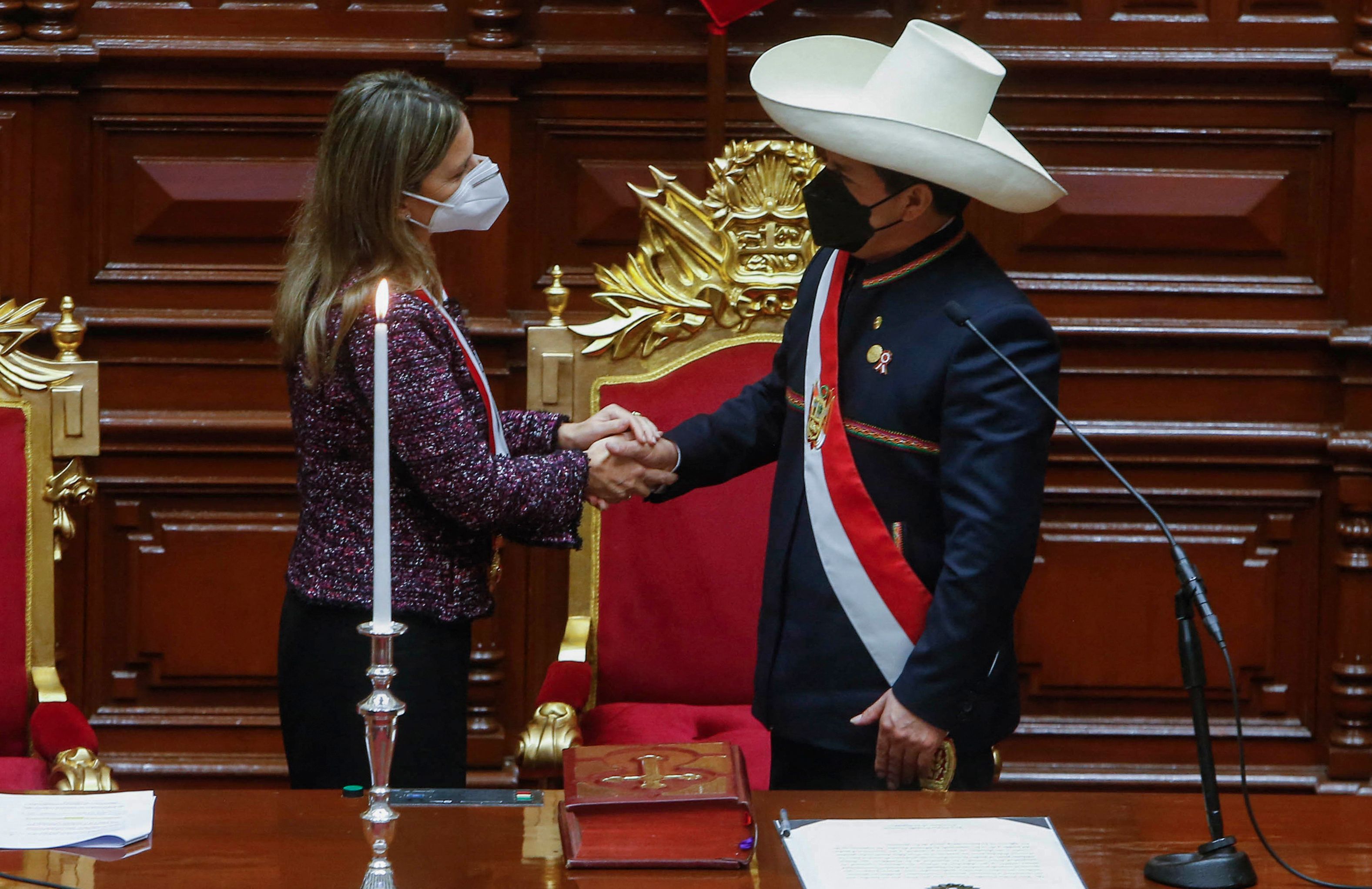 Handout picture released by the Peruvian presidency press office shows Peru's new President Pedro Castillo (R) greeting Congress President Maria del Carmen Alva after being invested as President during his inauguration ceremony at the National Congress in Lima, on July 28, 2021. - Leftist Pedro Castillo was sworn in as Peru's fifth president in three years Wednesday on the 200th anniversary of the country's independence, promising an end to corruption and a new constitution. (Photo by Karel Navarro / Peruvian Presidency / AFP) / RESTRICTED TO EDITORIAL USE - MANDATORY CREDIT "AFP PHOTO / PERUVIAN PRESIDENCY / KAREL NAVARRO" - NO MARKETING - NO ADVERTISING CAMPAIGNS - DISTRIBUTED AS A SERVICE TO CLIENTS