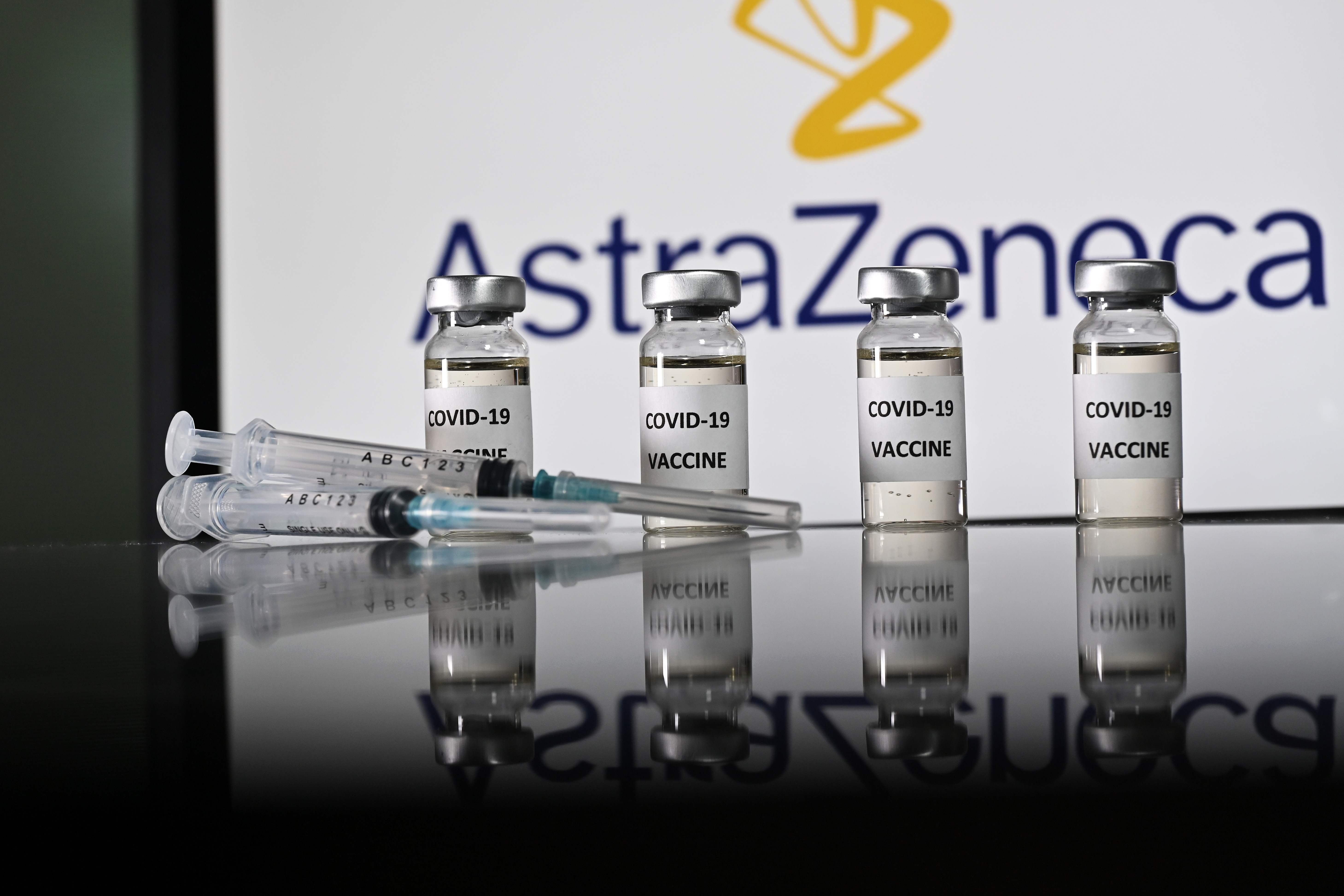 An illustration picture shows vials with Covid-19 Vaccine stickers attached and syringes with the logo of British pharmaceutical company AstraZeneca on November 17, 2020. (Photo by JUSTIN TALLIS / AFP)