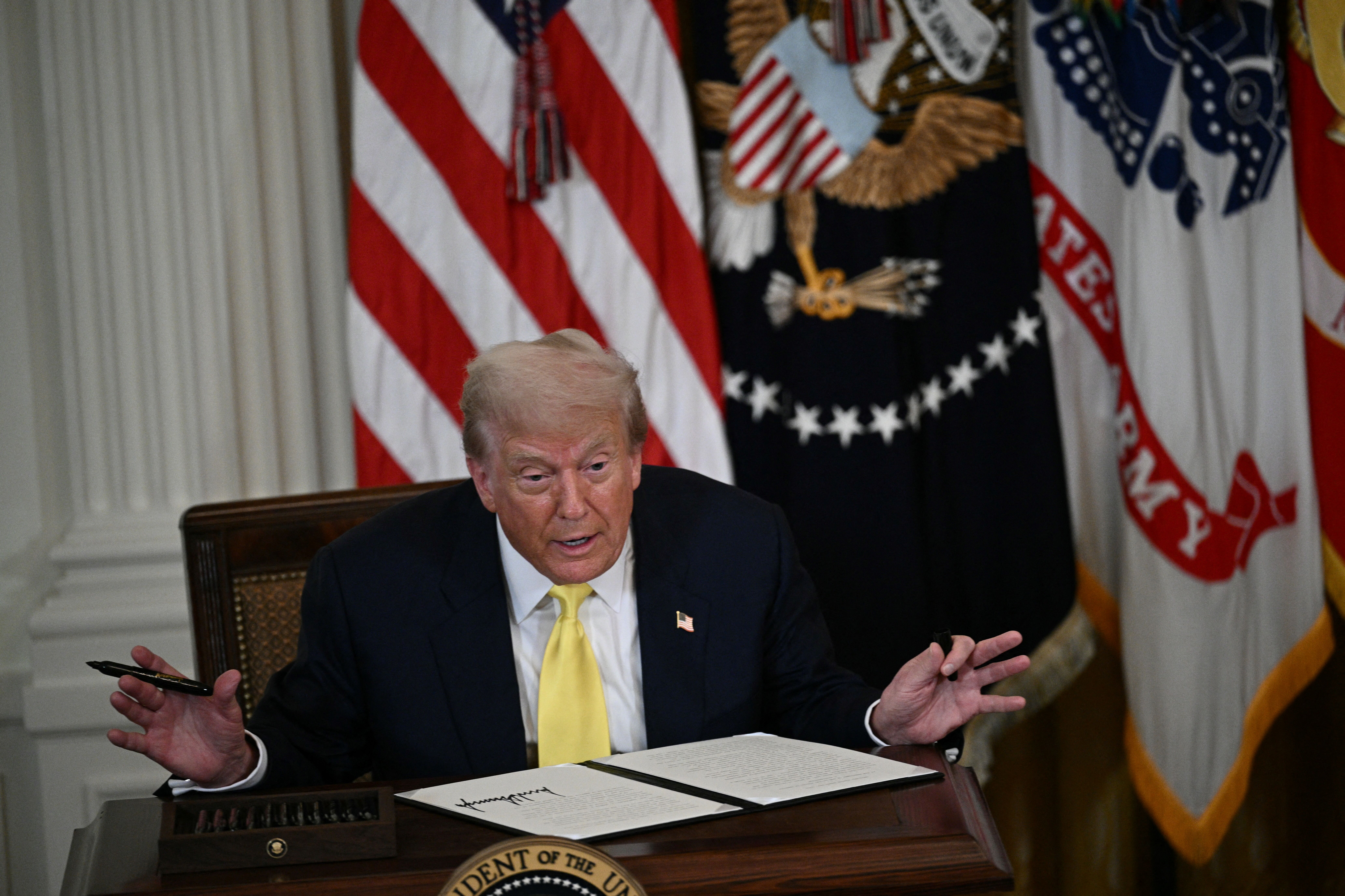 US President Donald Trump says he signed a proclamation affirming National Purple Heart Day without an autopen after delivering remarks at an event on National Purple Heart Day. The event was held in the East Room of the White House in Washington, DC on August 11. 7, 2025. (Photo by Brendan SMIALOWSKI / AFP)
