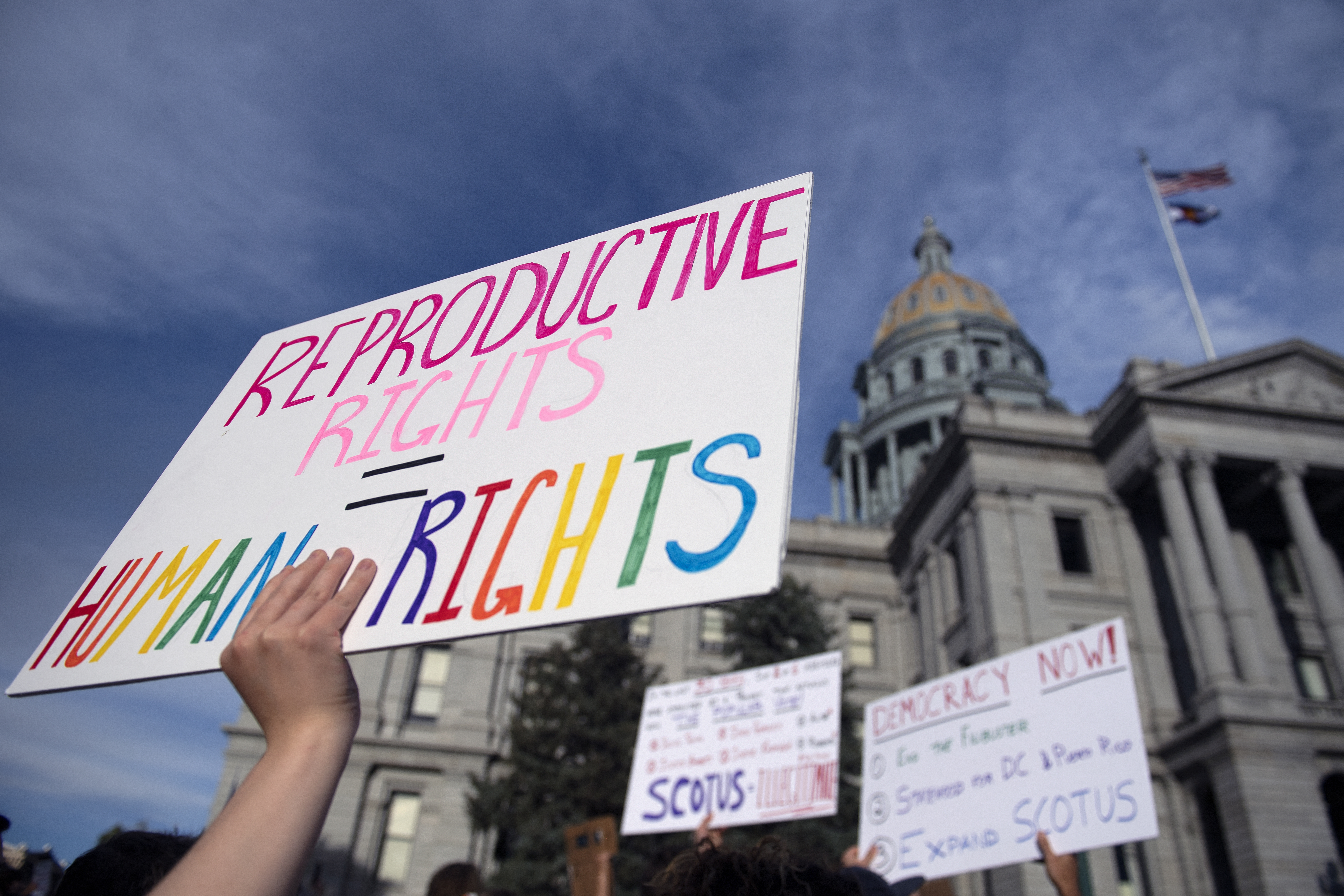 (FILES) In this file photo taken on June 27, 2022, abortion rights activists protest in front of the Colorado State Capitol in Denver, Colorado. - Trigger laws outlawing abortion took effect in a trio of US states on August 25, 2022, further restricting access to elective terminations for millions of women despite some signs of popular and judicial pushback. Two months after the Supreme Court struck down the constitutional right to abortion, nearly 21 million women have already lost access to the procedure in their home states, according to an analysis by The Washington Post. And with Idaho, Tennessee and Texas joining 10 other Republican-ruled states on Thursday in implementing near-total bans on abortion that number is set to rise. Another dozen states are expected to follow suit with their own restrictions. (Photo by Jason Connolly / AFP)