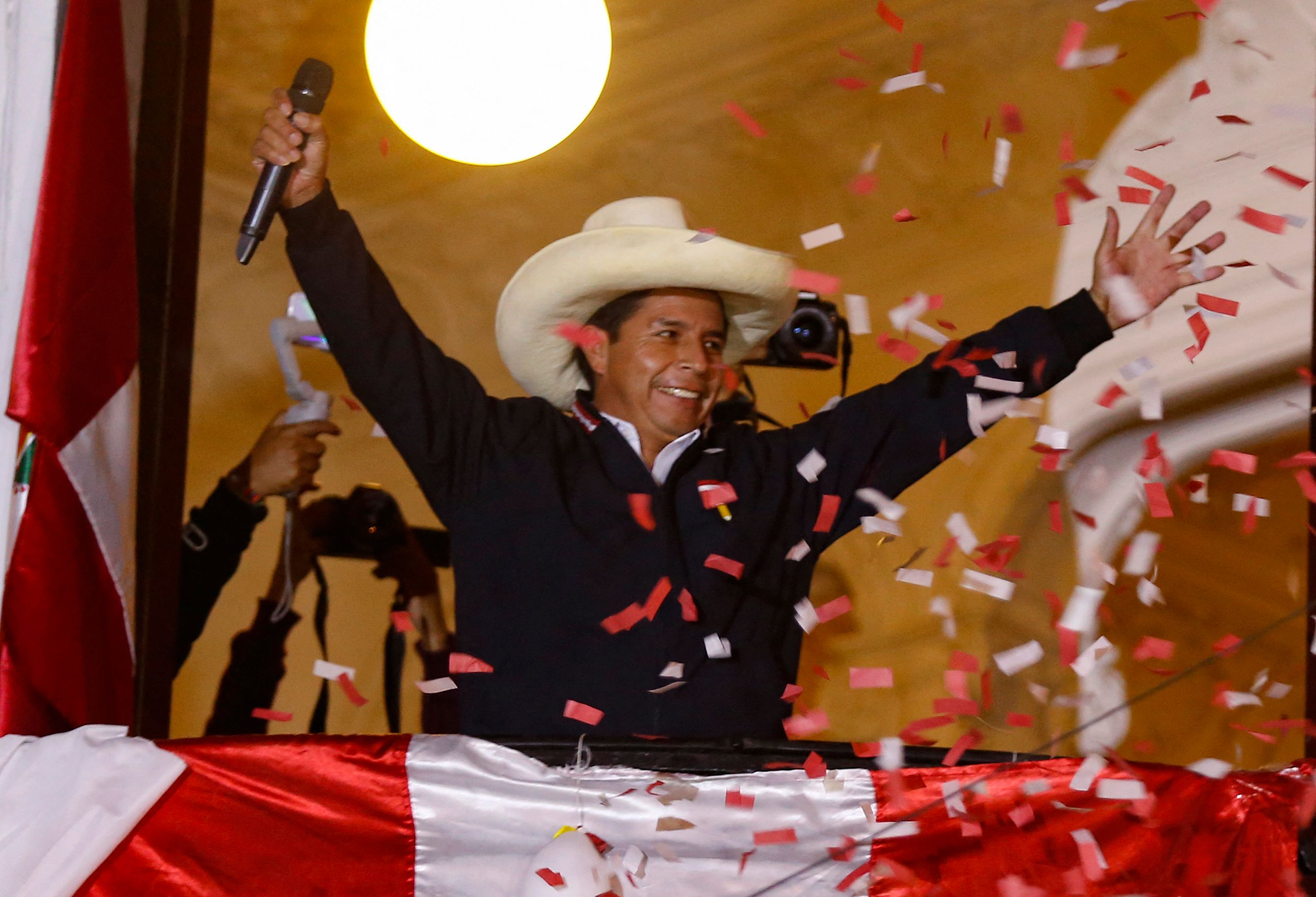 Peruvian leftist presidential candidate Pedro Castillo of Peru Libre waves to supporters from his party headquarters� balcony in Lima on June 8, 2021, keeping a narrow lead in the final vote tally with right-wing candidate Keiko Fujimori on Fuerza Popular following the runoff election of June 6. - Peru was on edge Tuesday as right-wing populist Keiko Fujimori cried foul after far-left rival Pedro Castillo took a narrow lead in the final stretch of vote-counting to decide who will be the country's next president. (Photo by Gian MASKO / AFP)