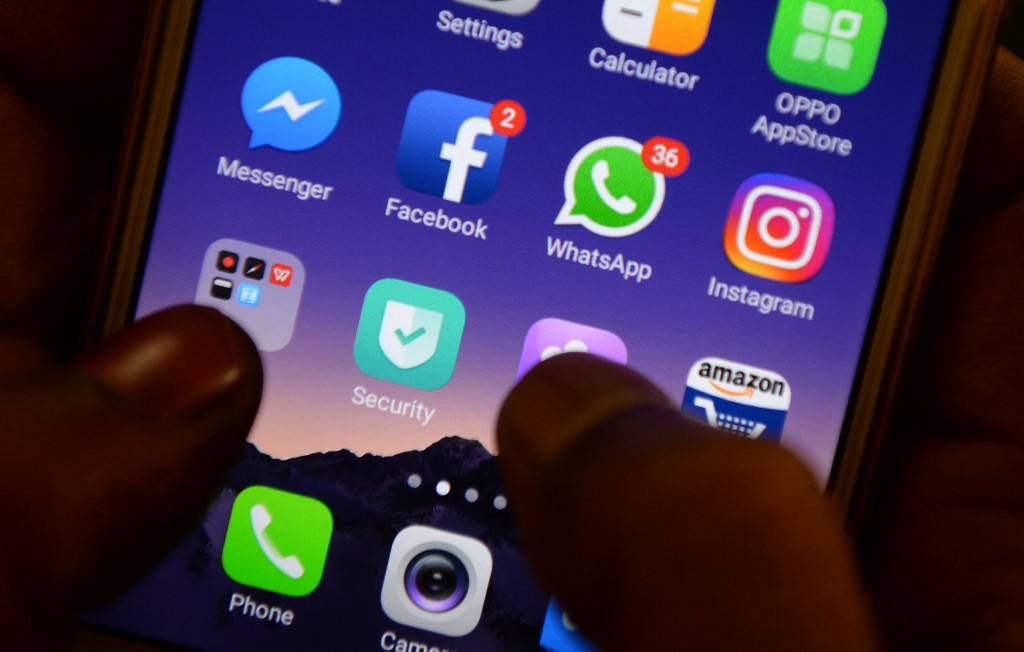 (FILES) This file photo illustration taken on March 22, 2018 shows apps for Facebook, Instagram, Whatsapp and other social networks on a smartphone in Chennai. - With their parents bombarding them on WhatsApp with misinformation and even abuse over their stand on India's new citizenship law, young women are hiding their identities on social media to voice outrage and find alternative families. (Photo by ARUN SANKAR / AFP)