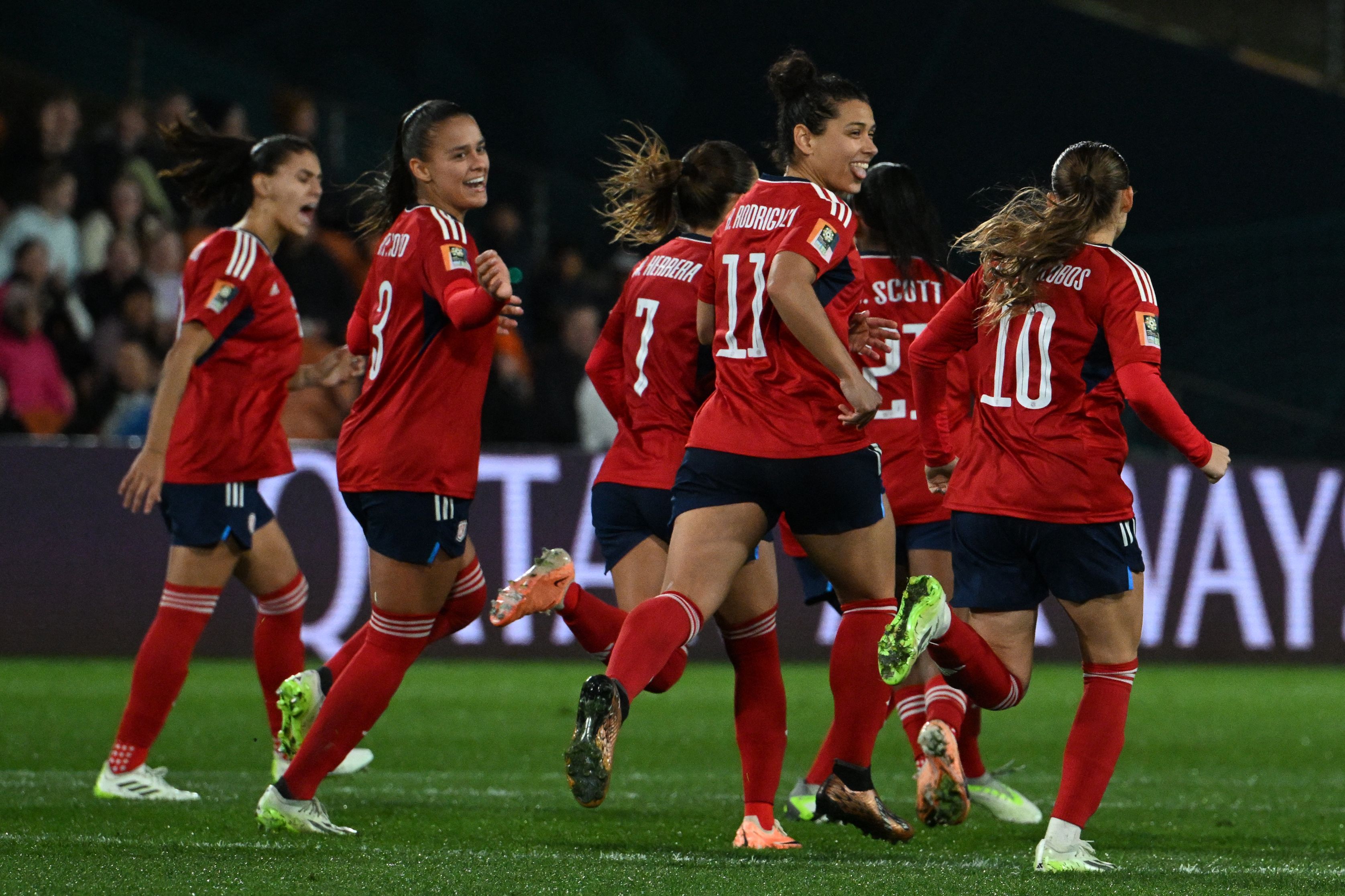 Costa Rica's players celebrate after Costa Rica's midfielder #07 Melissa Herrera (unseen) scored a goal during the Australia and New Zealand 2023 Women's World Cup Group C football match between Costa Rica and Zambia at Waikato Stadium in Hamilton on July 31, 2023. (Photo by Saeed KHAN / AFP)