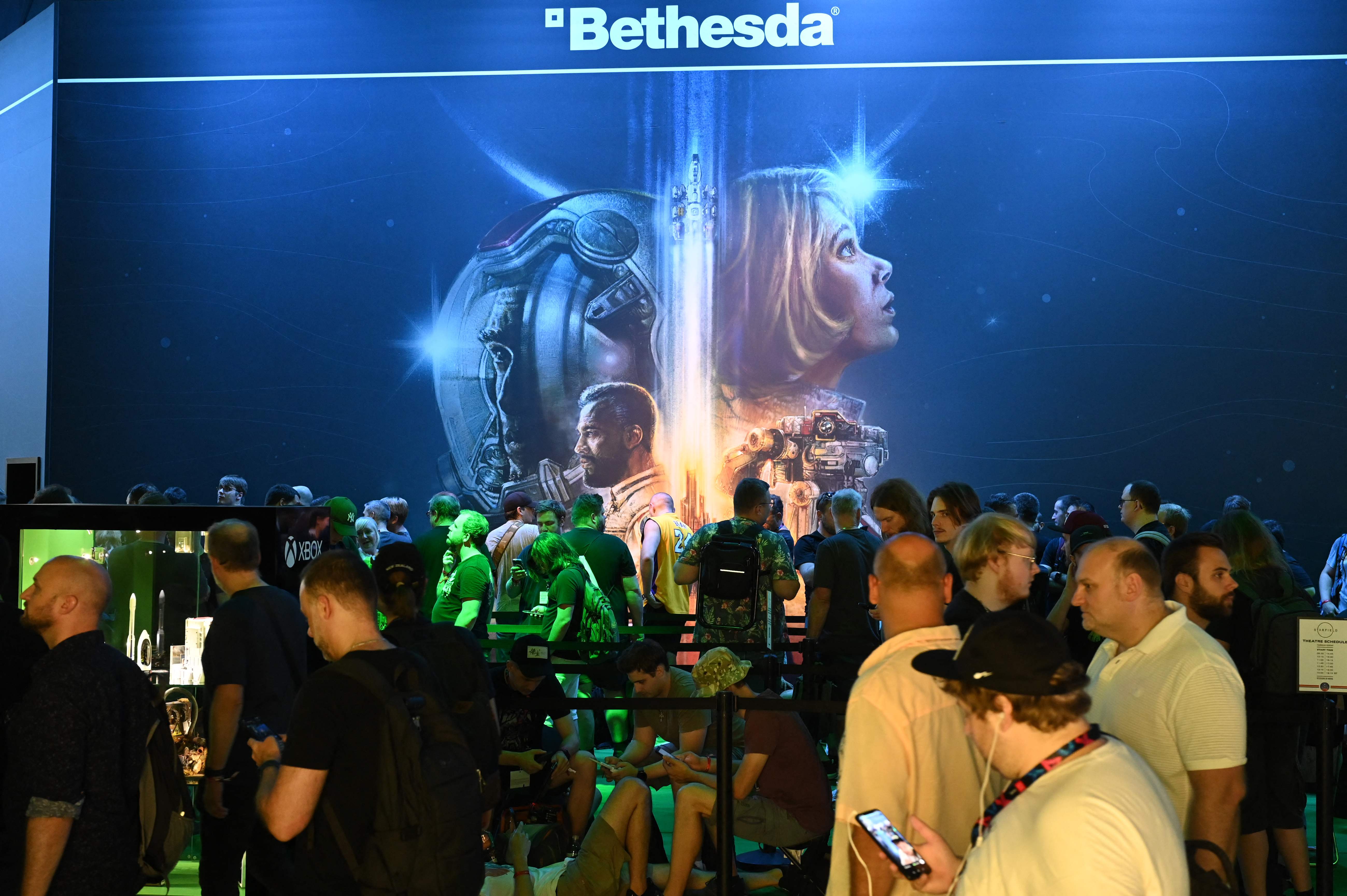 Visitors wait for a film of the Starfield game at the Xbox booth at the Gamescom video game fair in Cologne, western Germany, on August 23, 2023. According to the organisers, around 1,100 exhibitors from 53 countries will be presenting their products during the fair running until August 27, 2023. (Photo by Ina FASSBENDER / AFP)