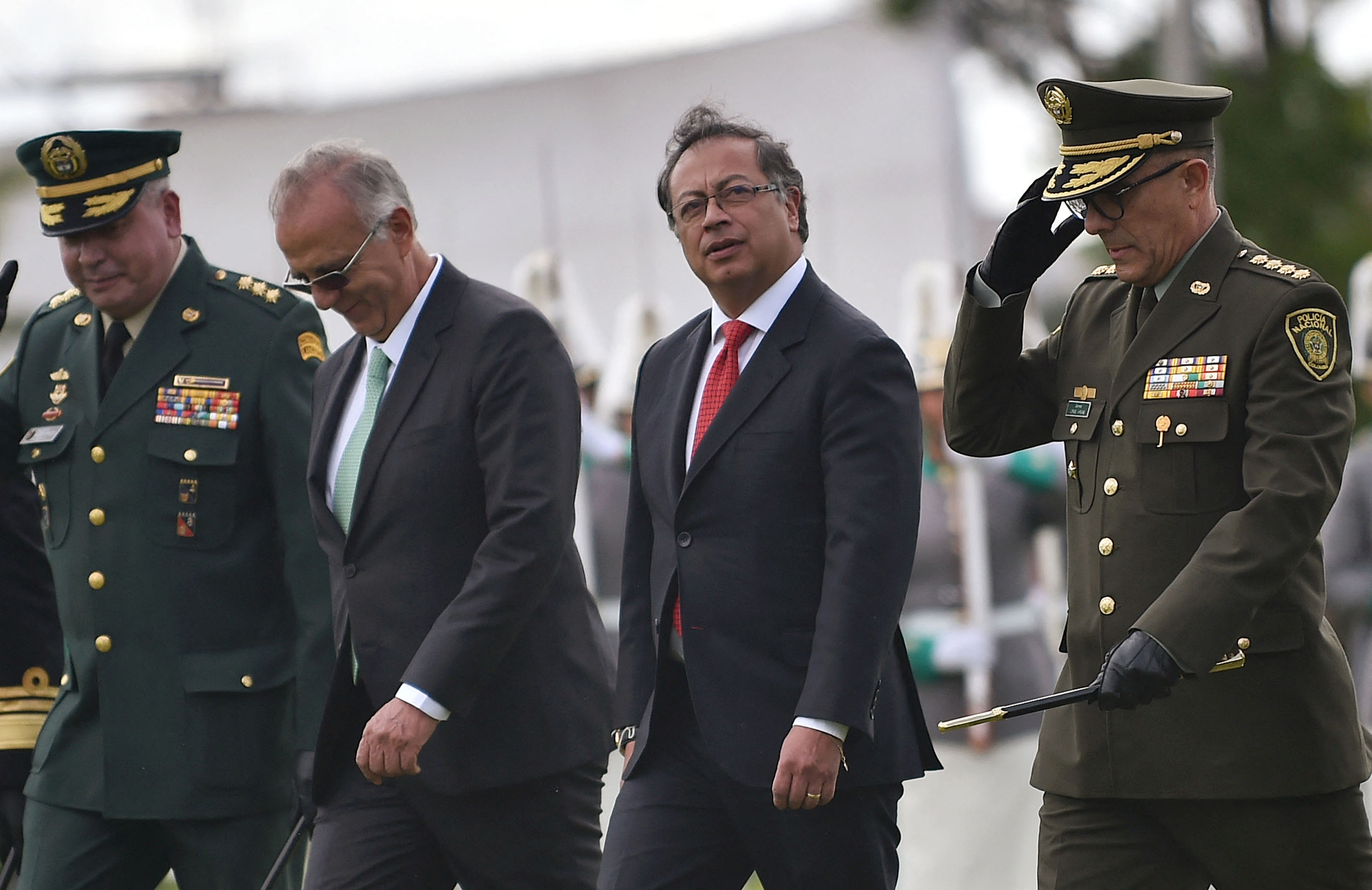 (L-R) Armed Forces Commander General Helder Giraldo, Colombia's Defense Minister Ivan Velasquez, Colombia's President Gustavo Petro and outgoing Police Director General Jorge Luis Vargas walk during a ceremony to appoint General Henry Sanabria as Police Director at the General Santander Police School in Bogota, on August 19, 2022. (Photo by DANIEL MUNOZ / AFP)