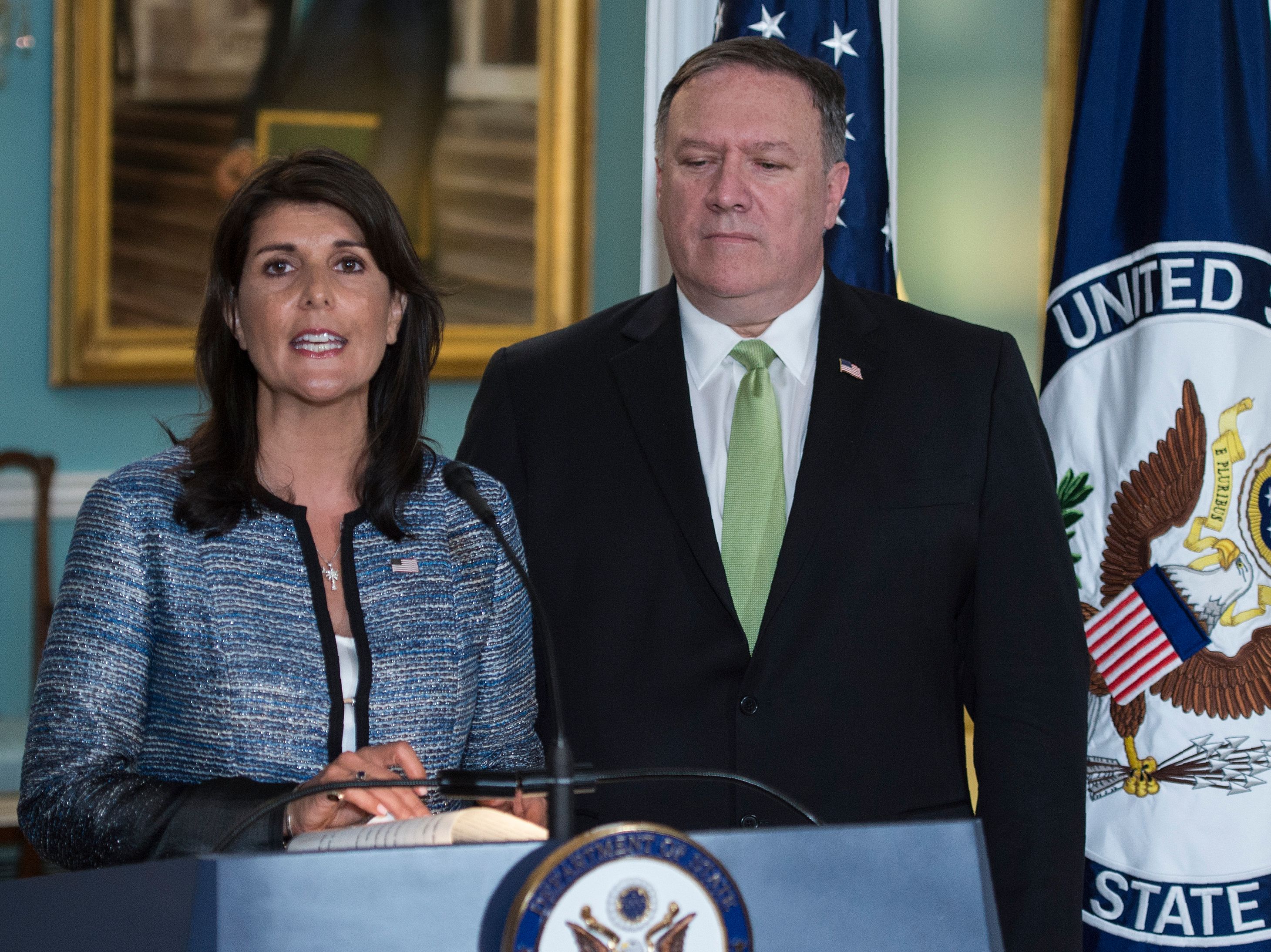 US Secretary of State Mike Pompeo looks on as US Ambassador to the United Nation Nikki Haley speaks at the US Department of State in Washington DC on June 19, 2018.
The United States announced that it is withdrawing from the UN Human Rights Council. / AFP PHOTO / Andrew CABALLERO-REYNOLDS