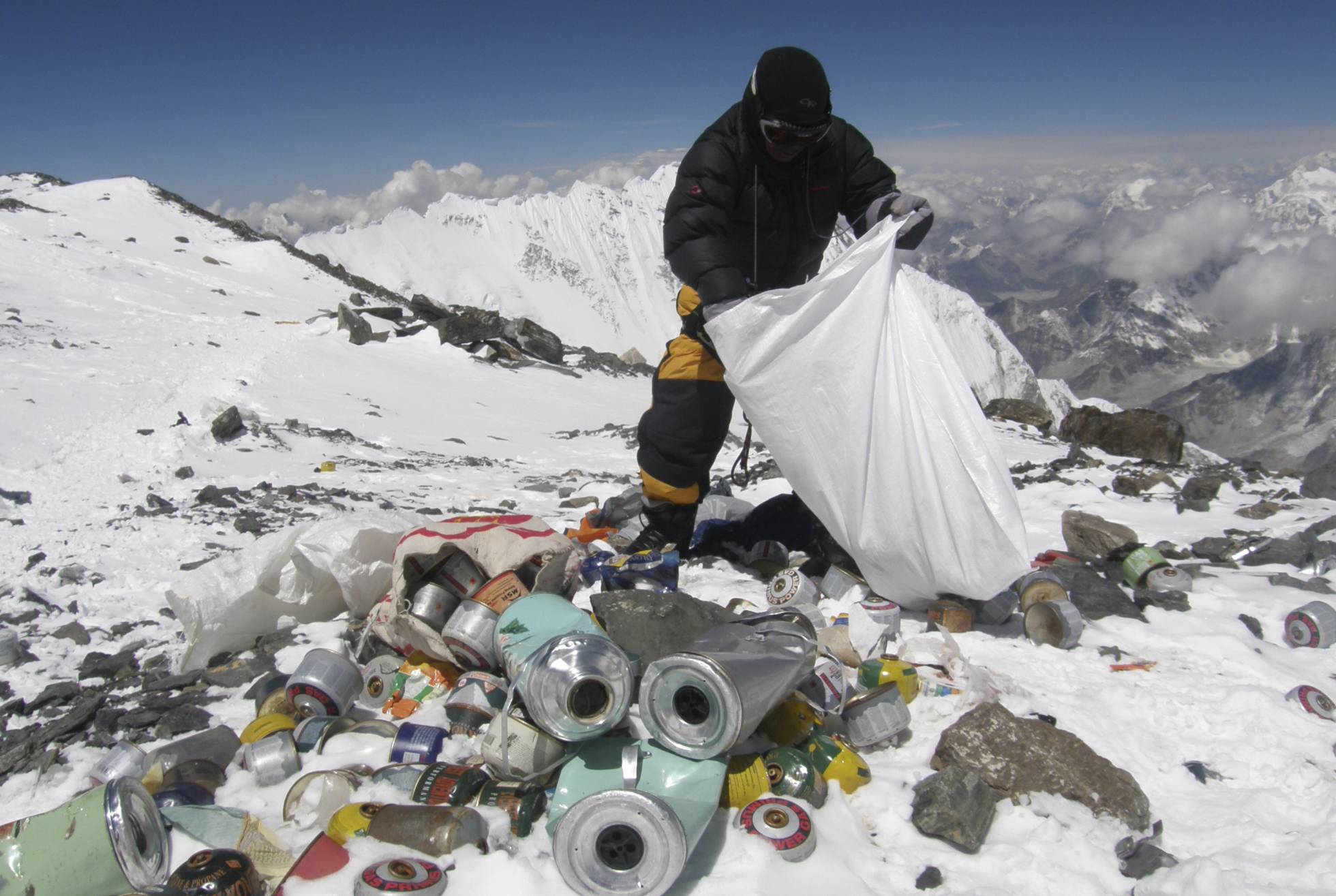 Un hombre recogiendo basura del Everest en 2010. NAMGYAL SHERPA/AFP
El monte Everest, con una altura de 8.848 metros, es el estercolero más alto del mundo. Una treintena de personas, que lleva limpiando la montaña desde el pasado mes de abril, ha recogido un total de 8,5 toneladas de residuos, de las que 2,3 toneladas son excrementos humanos, y una tonelada, equipos de alpinismo