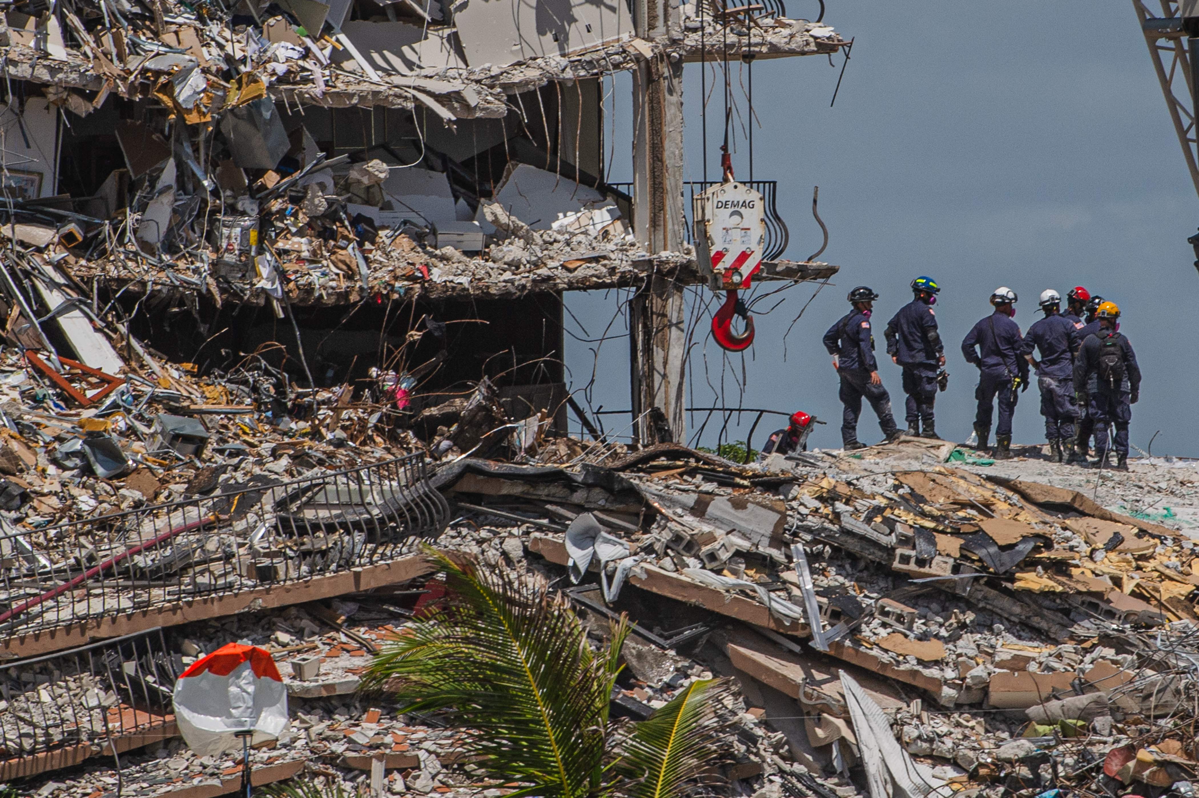 Search and Rescue teams look for possible survivors in the partially collapsed 12-story Champlain Towers South condo building on June 27, 2021 in Surfside, Florida. - The death toll after the collapse of a Florida apartment tower has risen to nine, the local mayor said on June 27, 2021, more than three days after the building pancaked as residents slept. "We were able to recover four additional bodies in the rubble... So I am confirming today that the death toll is at nine," Miami-Dade County mayor Daniella Levine Cava told reporters in Surfside, near Miami Beach, adding that one victim had died in hospital. "We've identified four of the victims and notified next of kin." (Photo by Giorgio Viera / AFP)