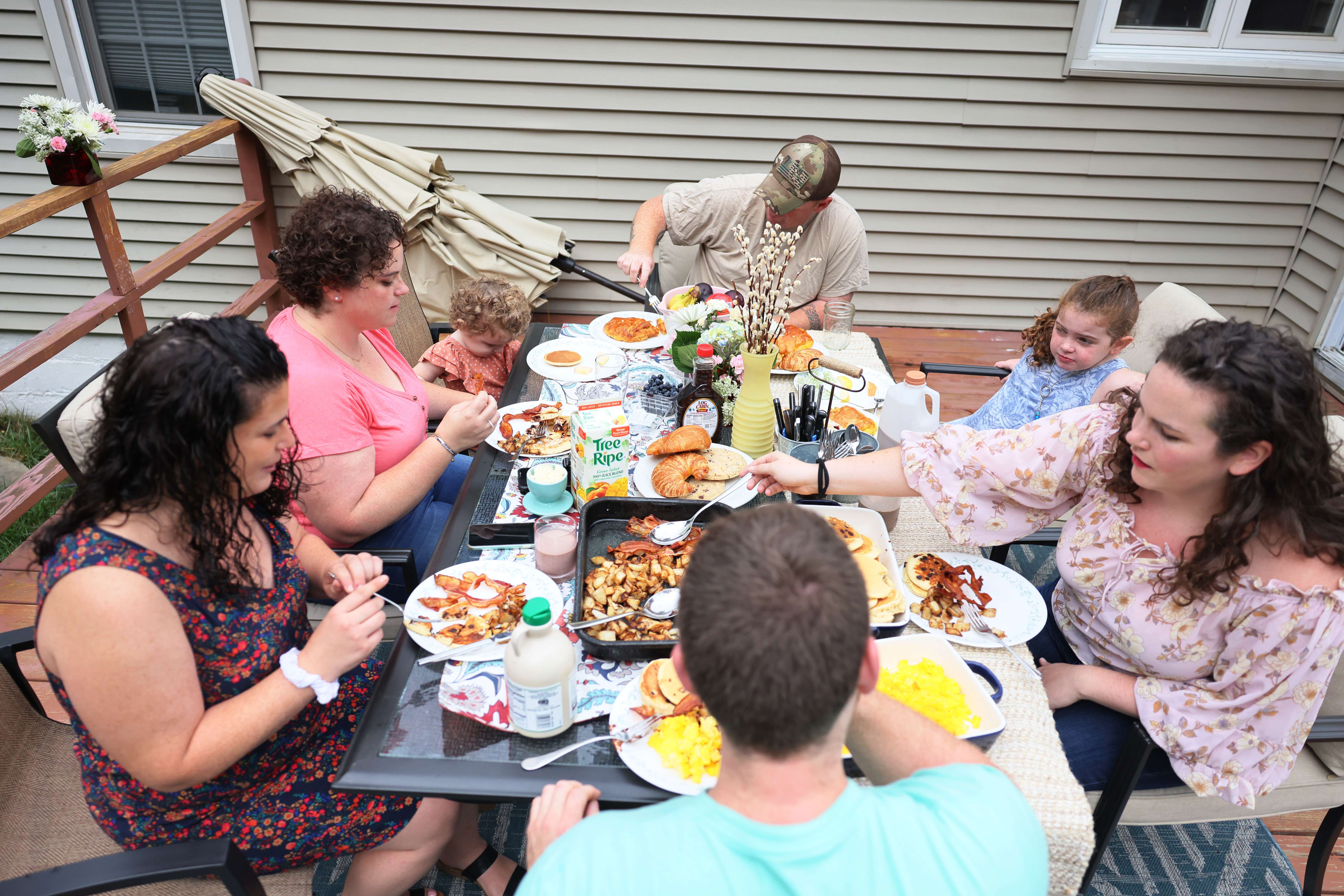CORTLANDT MANOR, NEW YORK - AUGUST 28: The family of former first responder John Coughlin enjoys a breakfast during a get together on August 28, 2021 in Cortlandt Manor, New York. John Coughlin, a 43-year-old NYPD Emergency Services sergeant with Truck 4, was one of 403 first responders who died in the terror attacks at the World Trade Center on September 11th, 2001. He is survived by his wife Patty and three daughters Erin, Tara, and Kayla. Both Erin and Kayla are now members of the NYPD, and Erin now wears the shield number of her late father. This year marks the 20th anniversary of the 9/11 attacks that killed nearly 3,000 people and injured more than 6,000 people in New York, the Pentagon and Pennsylvania. Michael M. Santiago/Getty Images/AFP
== FOR NEWSPAPERS, INTERNET, TELCOS & TELEVISION USE ONLY ==