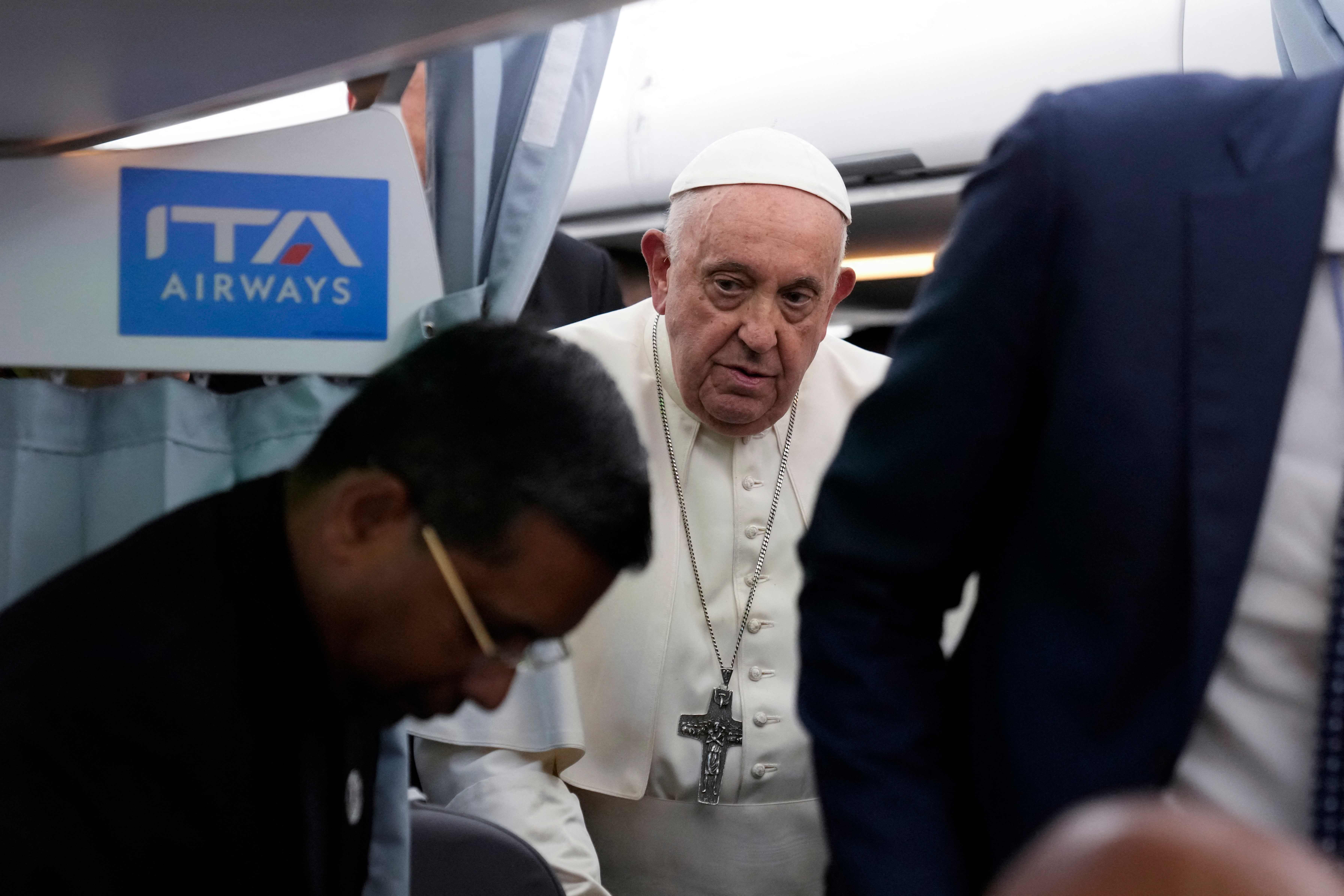 Pope Francis arrives for a press conference on board an airplane on his flight back from Marseille to Rome on September 23, 2023. The Pope just ended a two-day visit to Marseille where he joined Catholic bishops from the Mediterranean region on discussions largely focused on migration. (Photo by Alessandra Tarantino / POOL / AFP)
