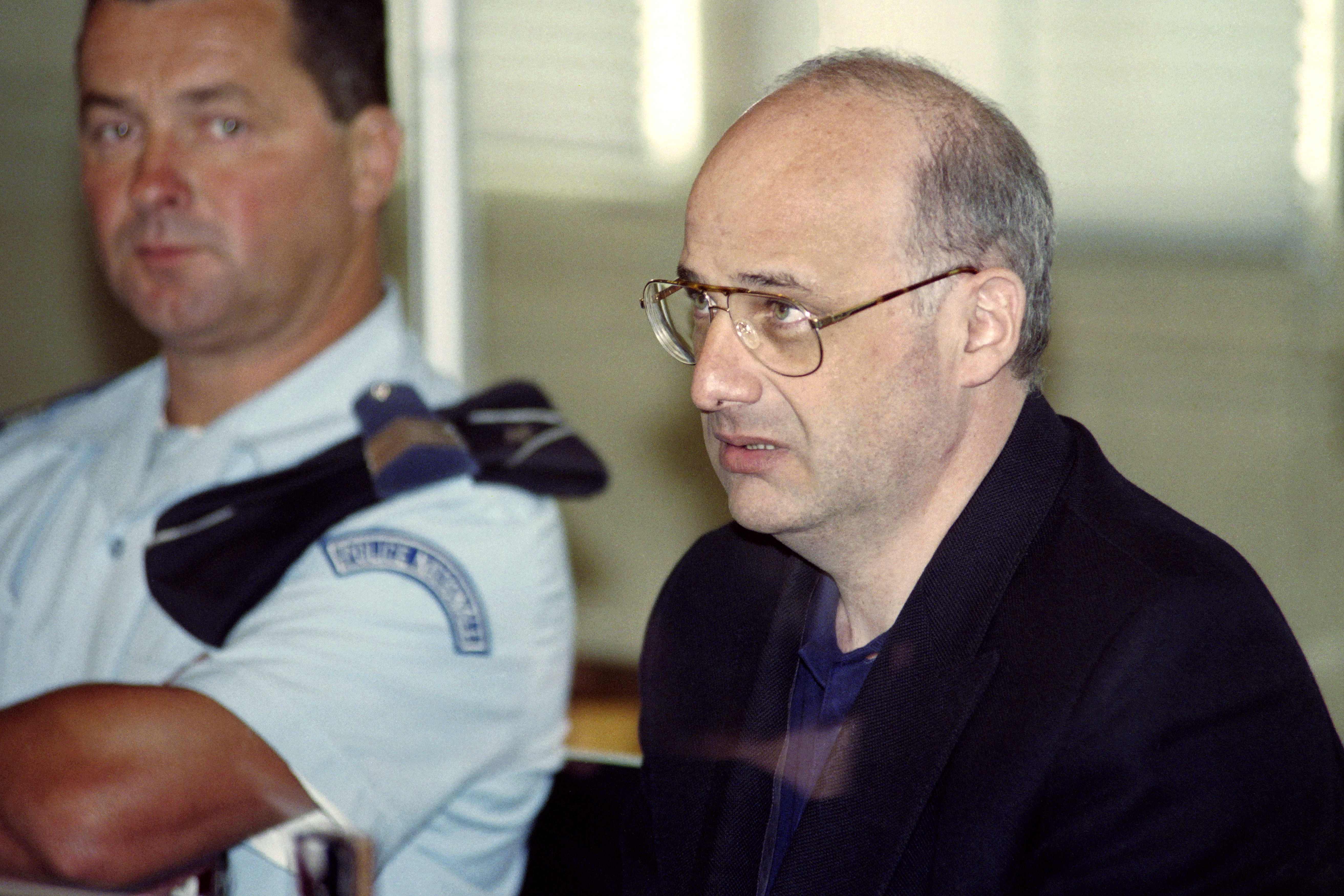 (FILES) In this file photo taken on June 25, 1996 Jean-Claude Romand, accused of the murder of his parents, his wife and children, attends his trial in the courthouse of Bourg-en-Bresse. - The application for parole of Jean-Claude Romand, sentenced to life in 1996 for the murder of his parents, his wife and children, will be examined on appeal on April 25, 2018. (Photo by PHILIPPE DESMAZES / AFP)