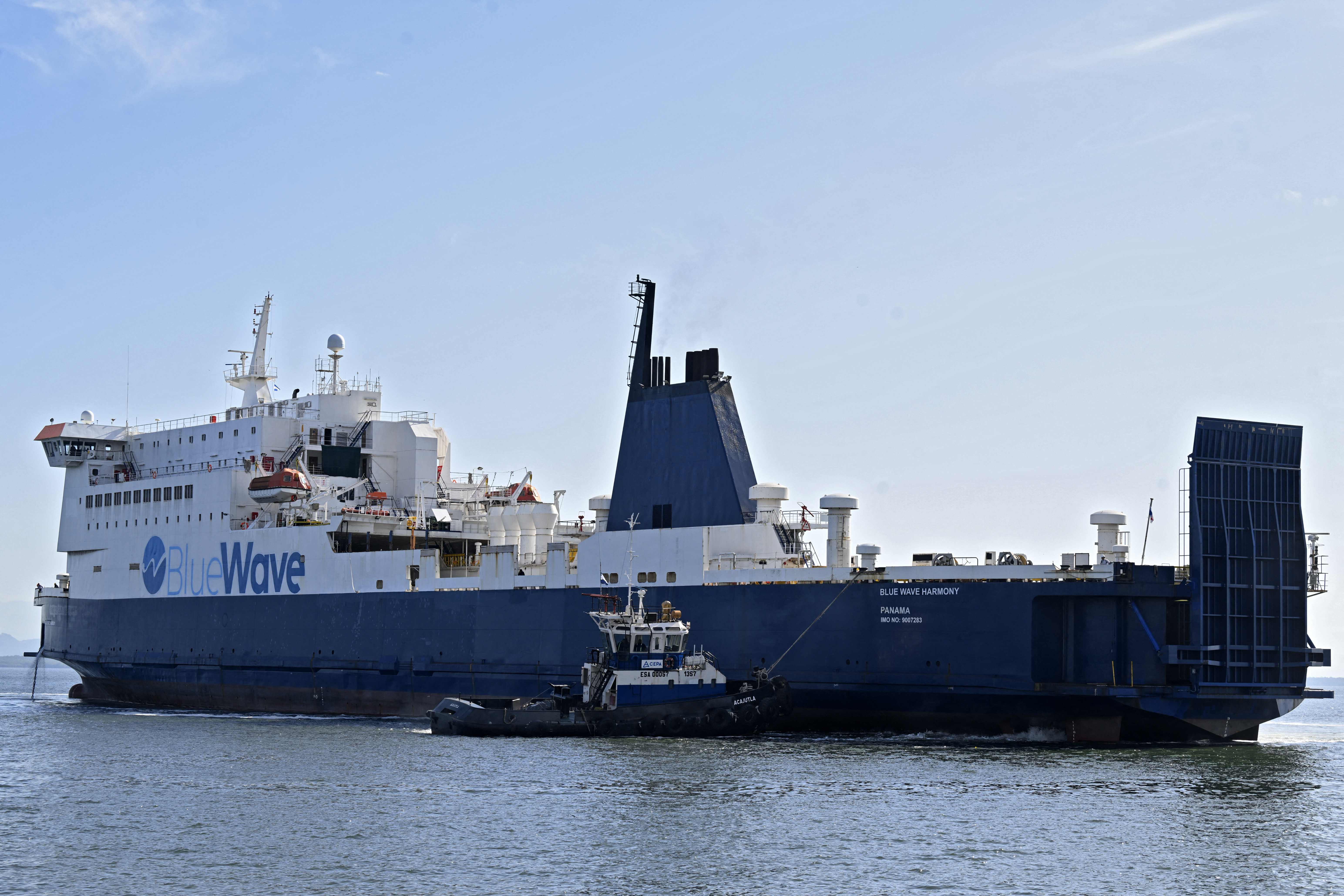The Panamanian-flagged "Blue Wave Harmony" ferry is seen on the maiden voyage that will connect El Salvador and Costa Rica through the Pacific Ocean, in the port of La Union, El Salvador, on August 10, 2023. A ferry with the capacity to transport a hundred containers or trucks with goods set sail Thursday on its maiden voyage from El Salvador to Costa Rica, opening a new era in Central American trade. The Panamanian-flagged "Blue Wave Harmony" began its voyage in the Salvadoran port of La Union, on the Gulf of Fonseca, and is due to dock some 16 hours later in Caldera, on the Costa Rican Pacific. (Photo by Marvin RECINOS / AFP)
