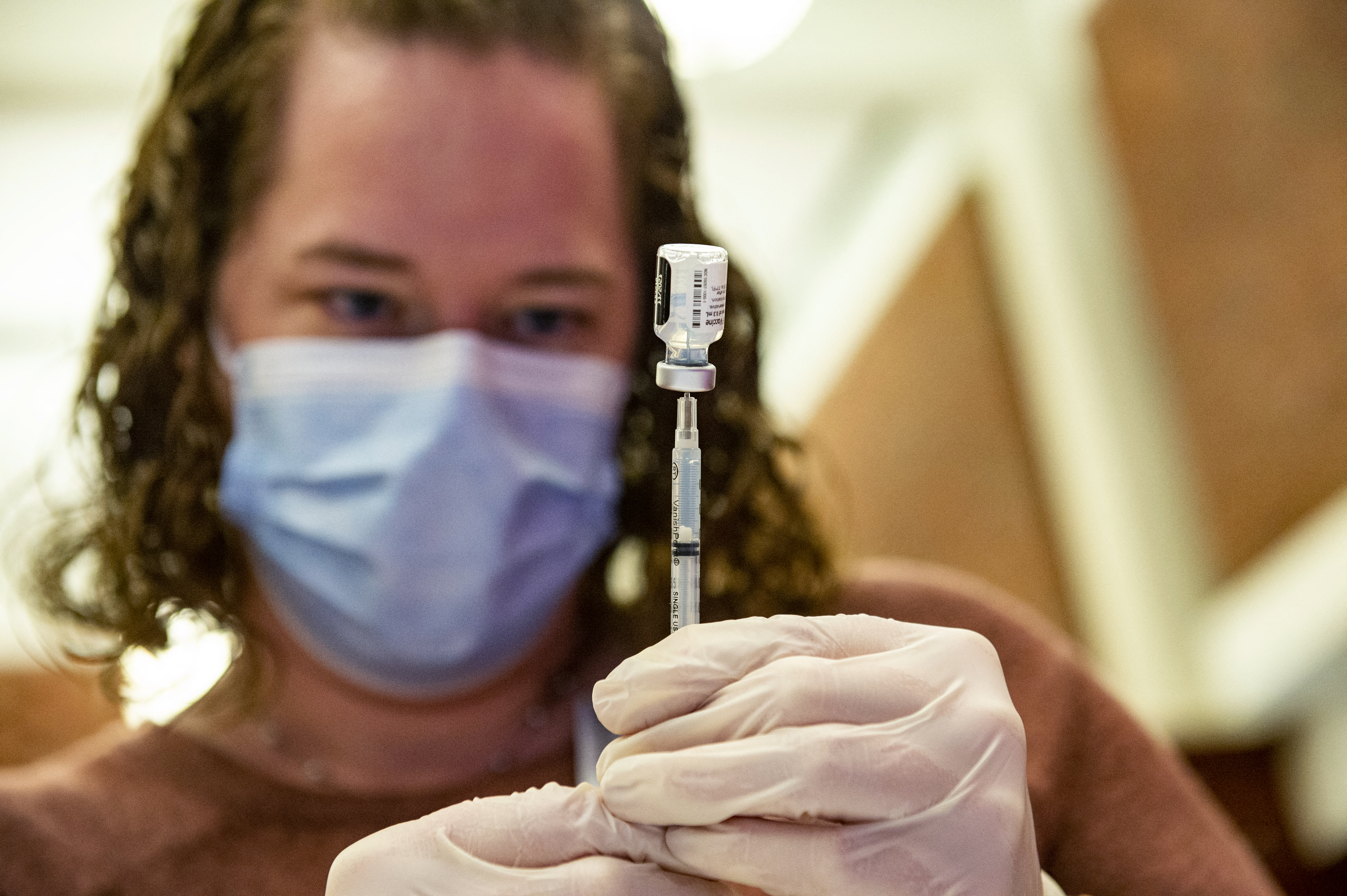 (FILES) In this file photo taken on January 06, 2022, a medical worker prepares the Pfizer-BioNTech Covid-19 vaccine booster to be given to children 12-15 years old at Hartford Hospital in Hartford, Connecticut. - US health officials on August 31, 2022, authorized updated Covid-19 vaccinations by Moderna and Pfizer-BioNTech that specifically target the latest strains of the Omicron variant, with the goal of jump-starting a new booster campaign. (Photo by Joseph Prezioso / AFP)