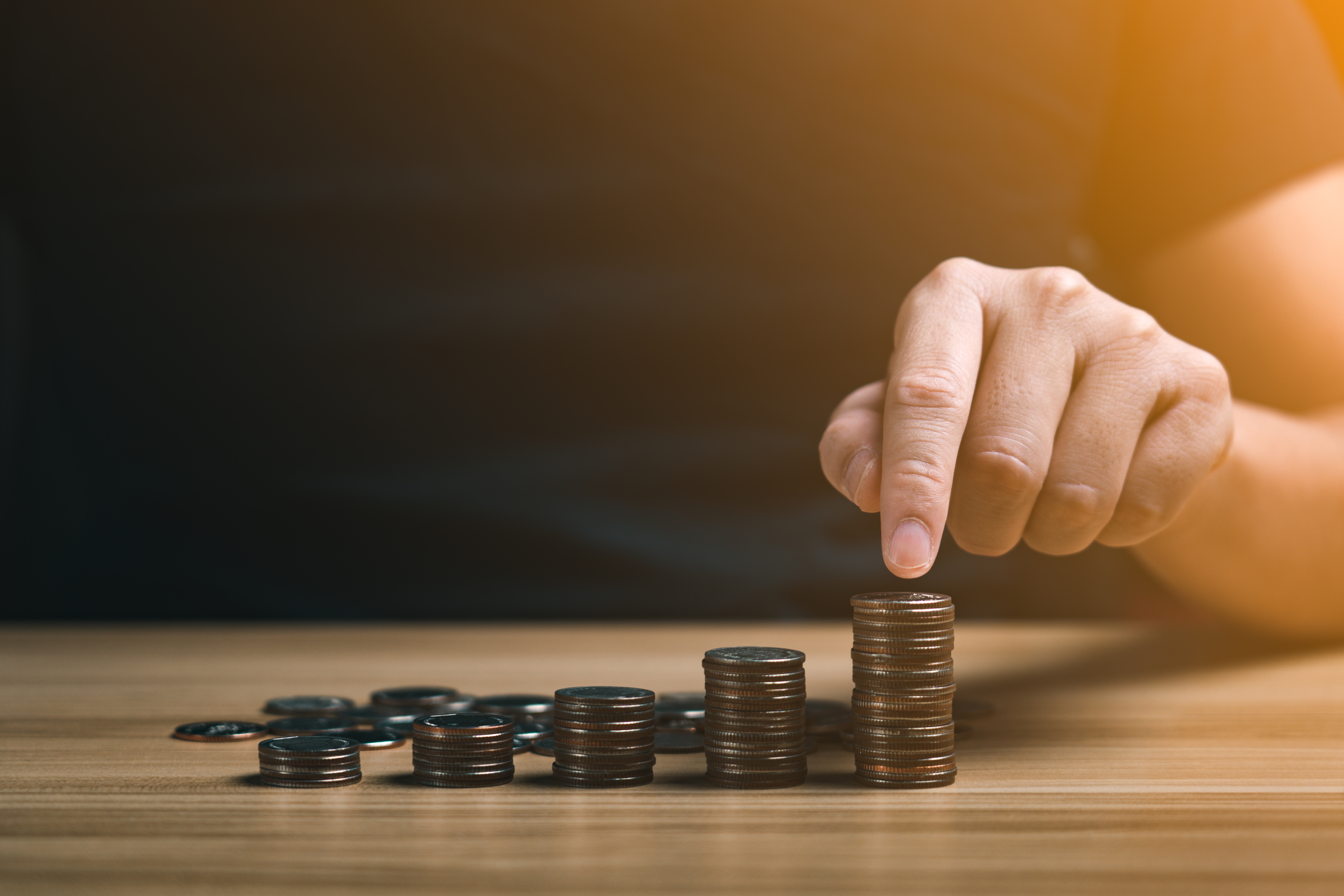 Businessman,Stacking,Coins.,Save,Money,And,Investment,Growth,Concept.,Savings