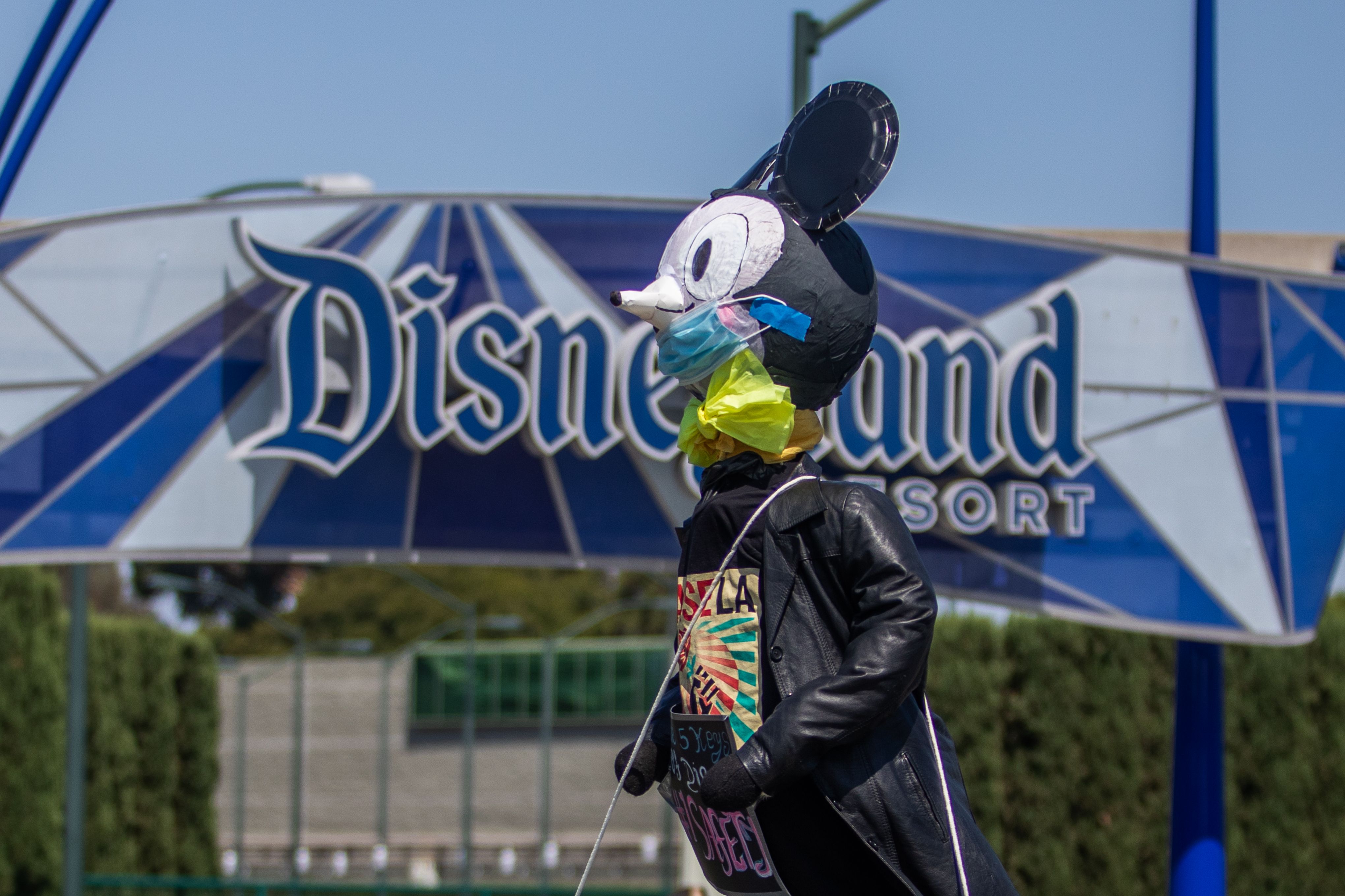 A makeshit Mikey Mouse on top of a car circles around Disneyland Resort calling for higher safety standards before its reopening July 17, amid the coronavirus pandemic in Anaheim, California on June 27, 2020. - A pair of Disneyland unions are calling upon more than 17,000 cast members to protest the proposed July 17 reopening of Disney�s Anaheim theme parks out of concern for employee safety. (Photo by Apu GOMES / AFP)