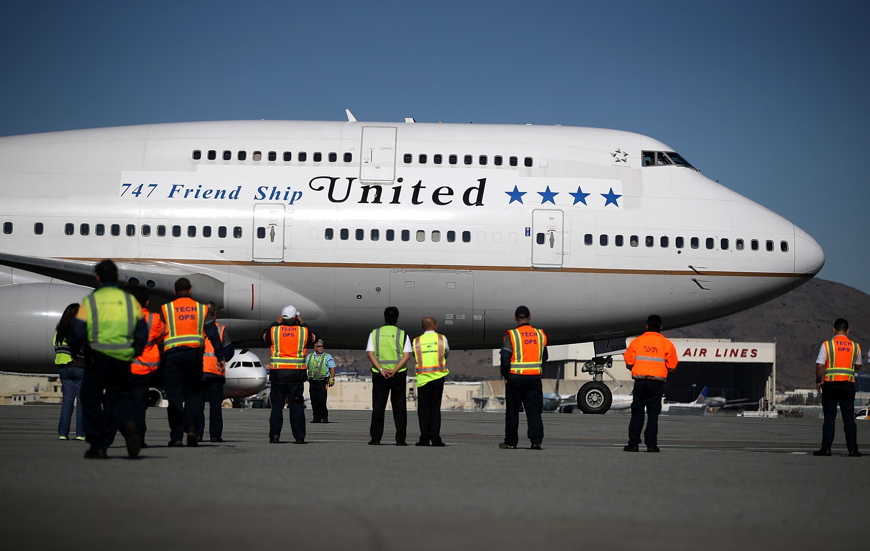 SAN FRANCISCO, CA - NOVEMBER 07: United Airlines workers look on as United Airlines flight 747 preapres to take off from San Francisco International Airport for its final flight to Honolulu, Hawaii on November 7, 2017 in San Francisco, California. United Airlines is retiring its fleet of Boeing 747 aircraft that are affectionately known as the �Queen of the Skies� and marked the occassion with a final flight from San Francisco to Honolulu, Hawaii. Justin Sullivan/Getty Images/AFP / AFP PHOTO / GETTY IMAGES NORTH AMERICA / JUSTIN SULLIVAN
