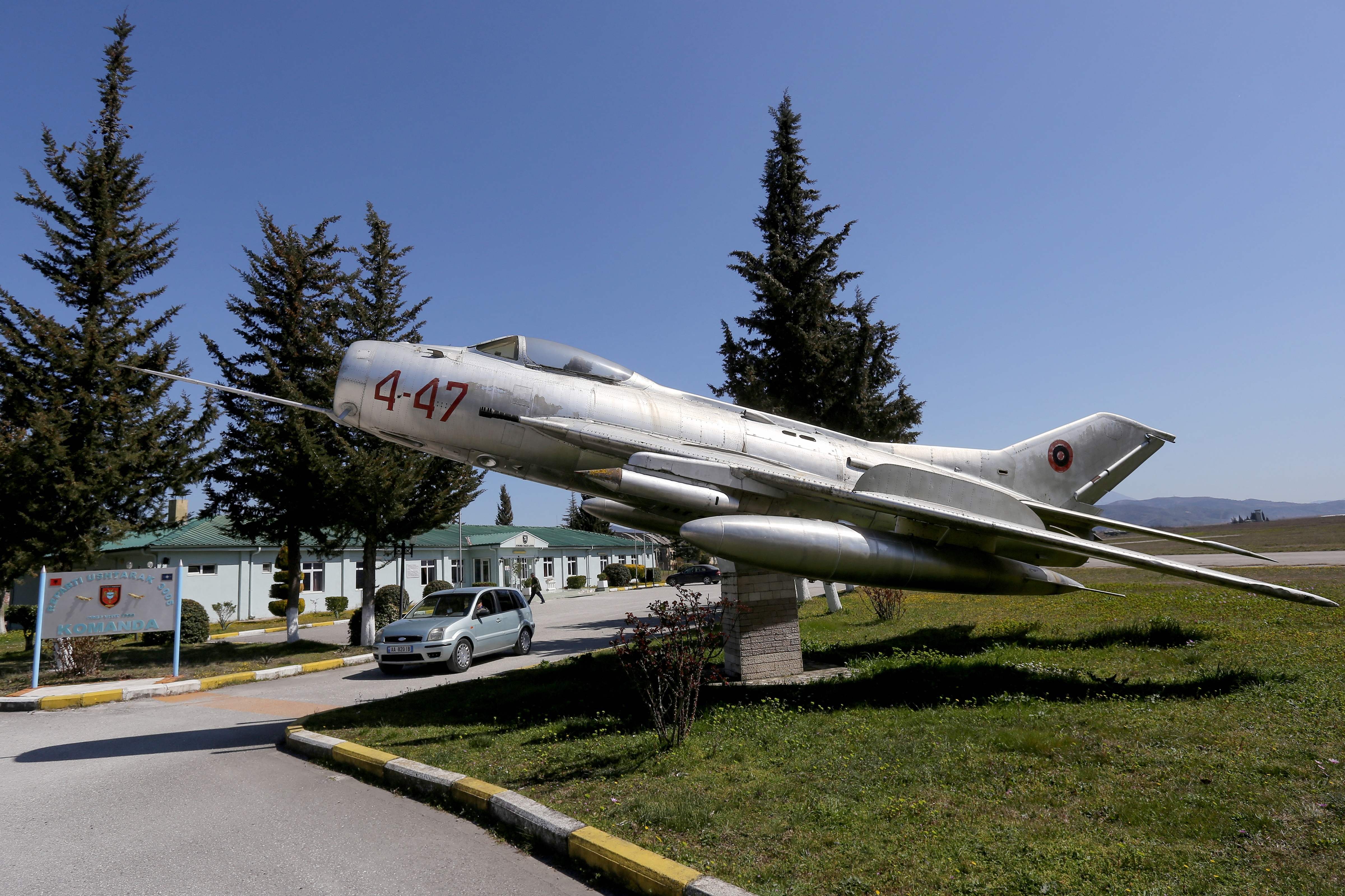 A MiG-19 jet fighter is pictured in Kucova Air Base, which will turn into a NATO air base on March 23, 2022. - Dozens of old Soviet- and Chinese-made MiG jets rust in the open air in a former communist military base in an Albanian city once named after Stalin. After the fall of the communist regime in 1990, ending four decades of dictatorship, Stalin regained its former name Kucova. (Photo by Gent SHKULLAKU / AFP)