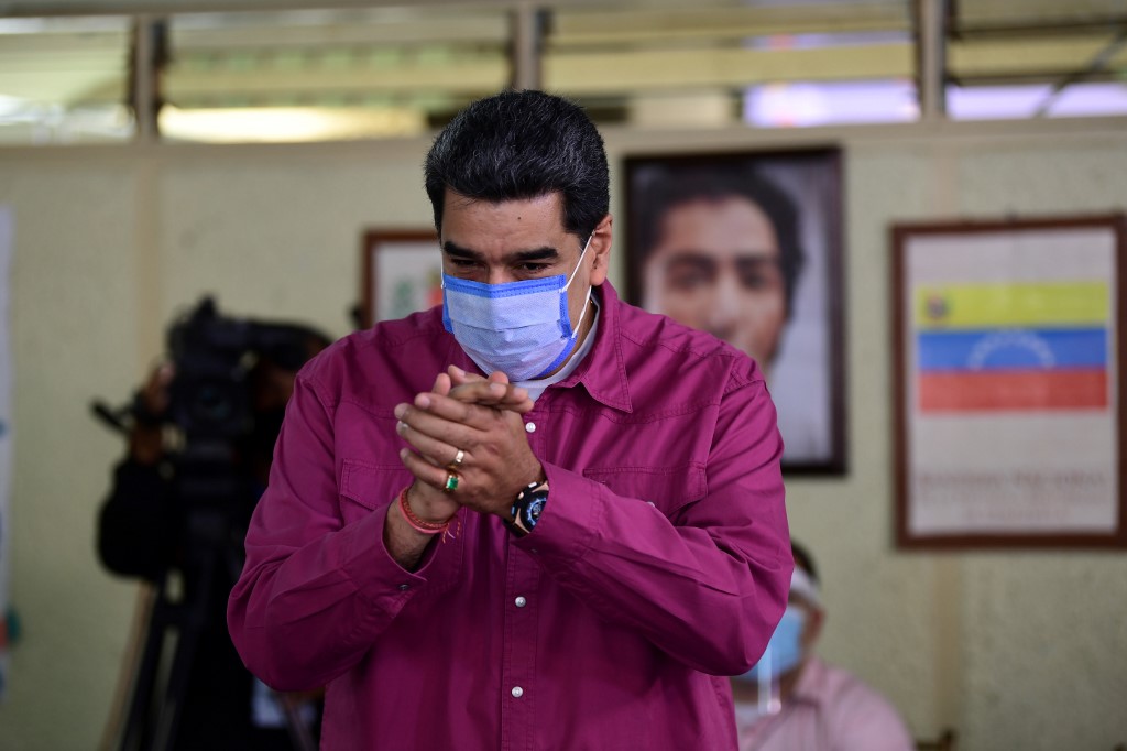 Venezuelan President Nicolas Maduro gestures after casting his vote at a polling station in the Simon Rodriguez school in Fuerte Tiuna, Caracas, on December 6, 2020 during Venezuela's legislative elections. - Polls opened early December 6 in legislative elections set to tighten Venezuelan President Nicolas Maduro's grip on power and weaken his US-backed rival, who is leading a boycott of the polls he calls a fraud. Maduro and his allies are set to dominate the legislative elections, which victory will give them control of the National Assembly, the only institution not yet in its hands. (Photo by YURI CORTEZ / AFP)