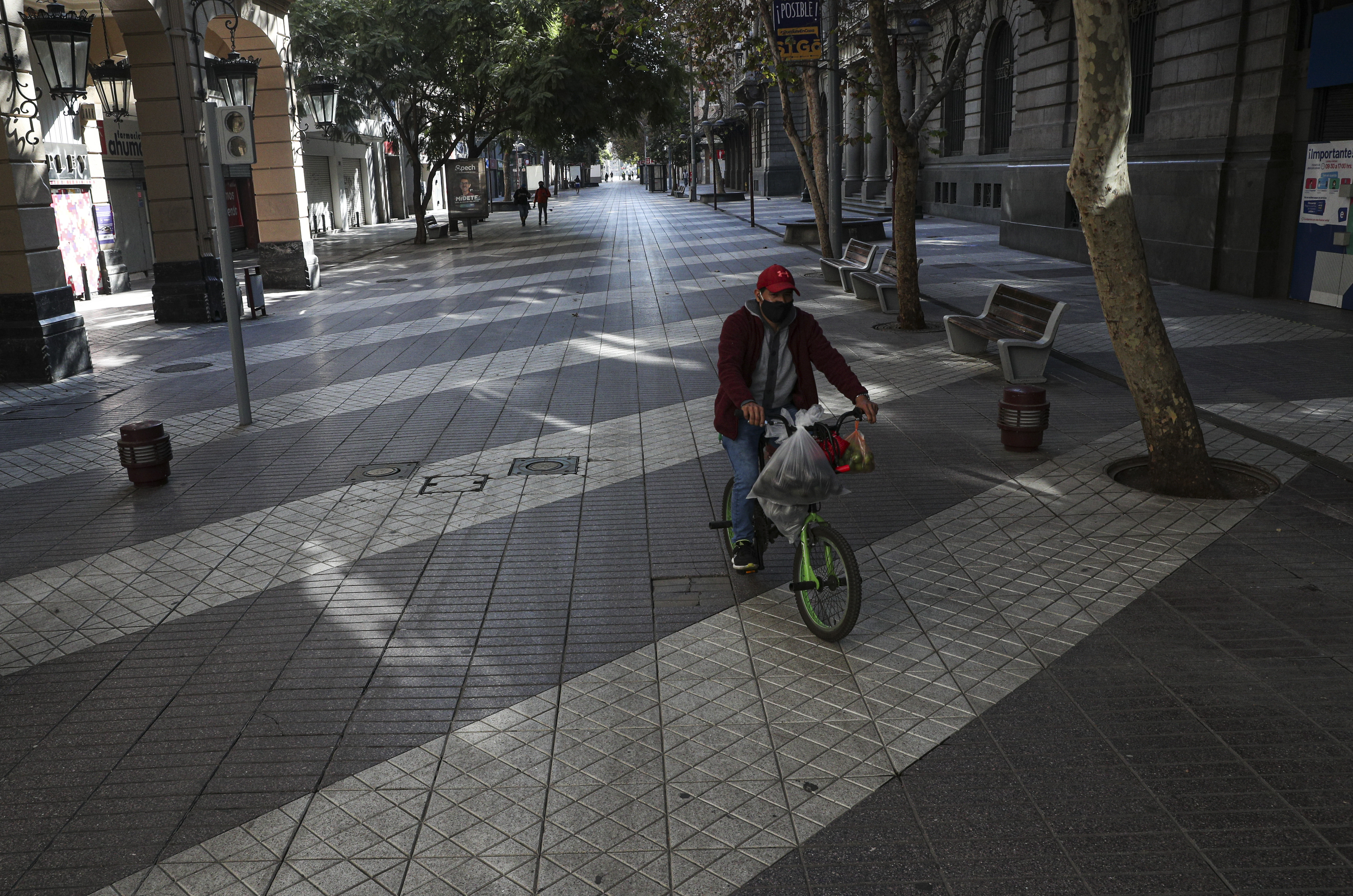 A bicyclist rides freely through the iconic pedestrian zone Paseo Ahumada in Santiago, Chile, Saturday, May 16, 2020, amid the new coronavirus pandemic. (AP Photo/Esteban Felix)