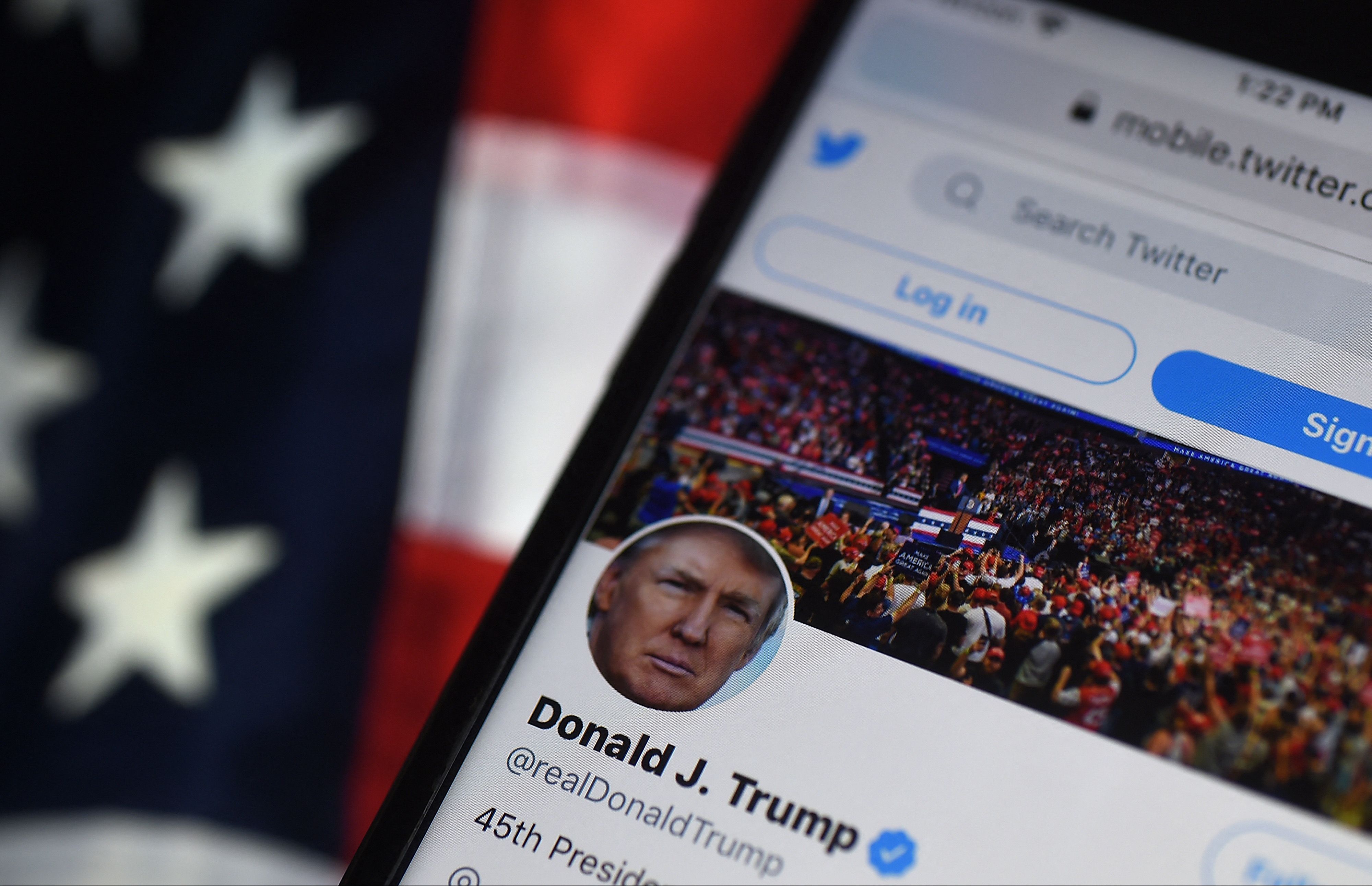 (FILES) In this file photo illustration taken on August 10, 2020, the Twitter account of US President Donald Trump is displayed on a mobile phone on August 10, 2020, in Arlington, Virginia. - Formewr President Trump has filed suit asking a court to reinstate his account on Twitter and restore the online voice he lost for allegedly instigating the Capitol Hill riot. Twitter and other social media banned the former president from their platforms after a mob of pro-Trump supporters assaulted the US Congress building on January 6. (Photo by Olivier DOULIERY / AFP)