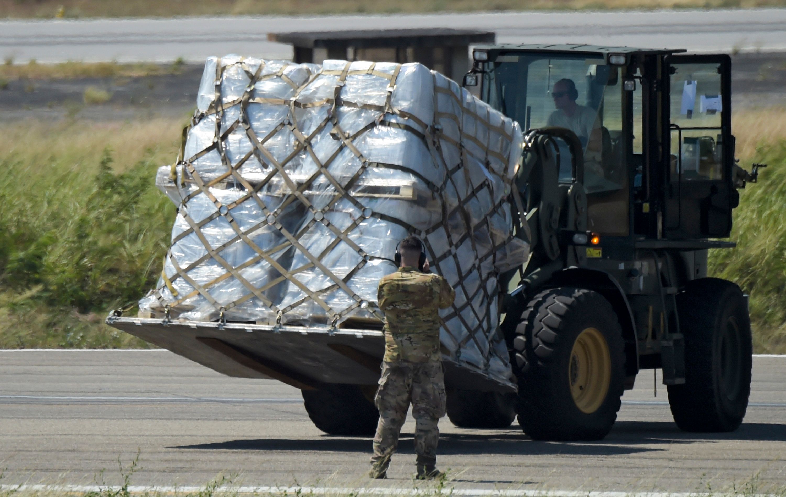 A truck is loaded with humanitarian aid for Venezuela after US Air Force C-17 aircrafts landed at Camilo Daza International Airport in Cucuta, Colombia, on the border with Venezuela on February 16, 2019. - Venezuelan opposition leader Juan Guaido on Saturday called for nationwide protests next week to support volunteers planning to travel to the border with Colombia to bring in US humanitarian aid, the latest flashpoint in the country's political crisis. The announcement came as tons of US food aid was piling up along the border. It has been denounced by President Nicolas Maduro, who has asked the military to reinforce the frontier, denouncing the food as a "booby trap" and a cover, he said, for a planned US military invasion. (Photo by Raul ARBOLEDA / AFP)