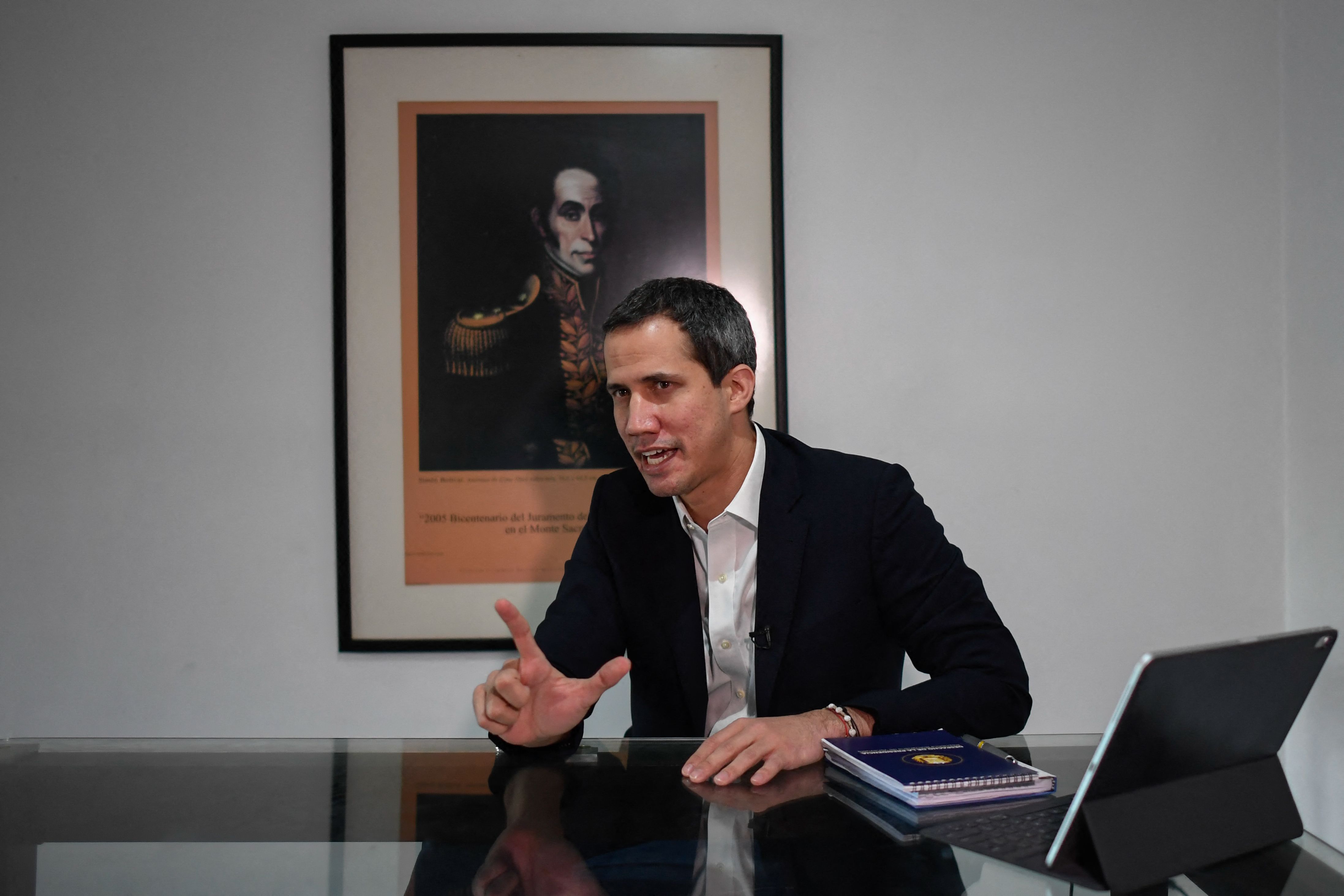 Venezuelan opposition leader Juan Guaido gestures as he speaks during an interview with the AFP at his home in Caracas on August 25, 2021. (Photo by Federico PARRA / AFP)
