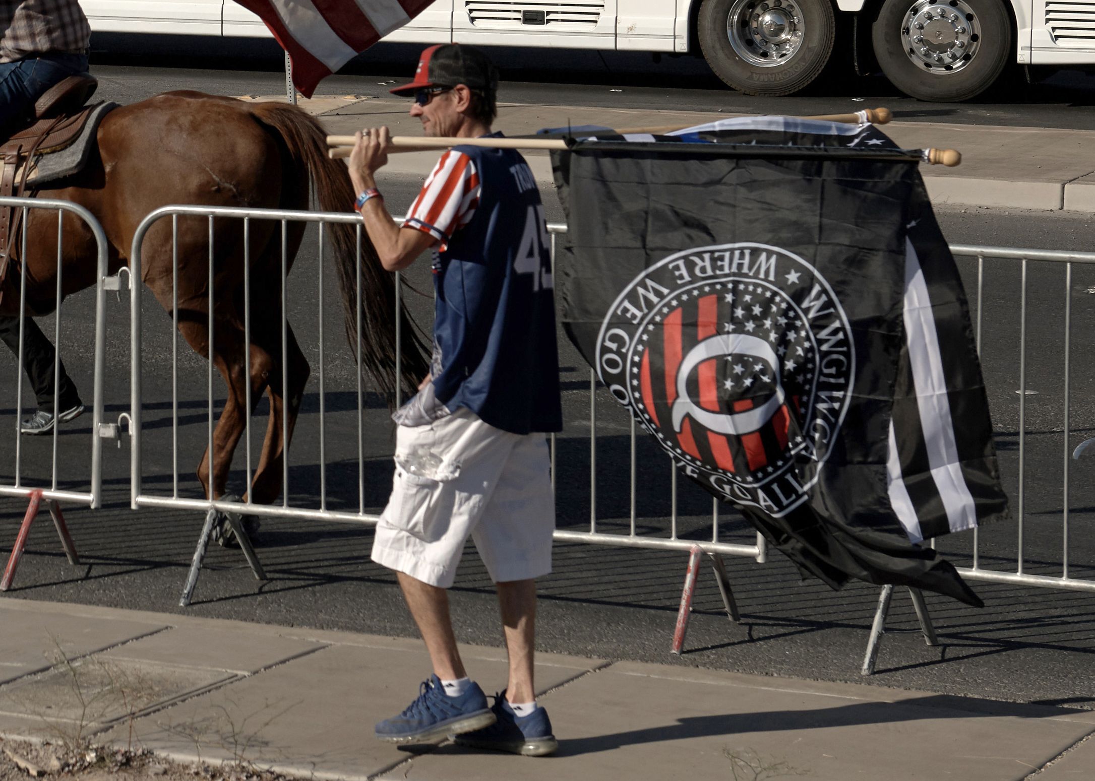 A man hols a "QAnon" flag, outside the "Great American Comeback Event" campaign rally with US President Donald Trump at Xtreme Manufacturing in Henderson, Nevada on September 13, 2020. (Photo by Bridget BENNETT / AFP)