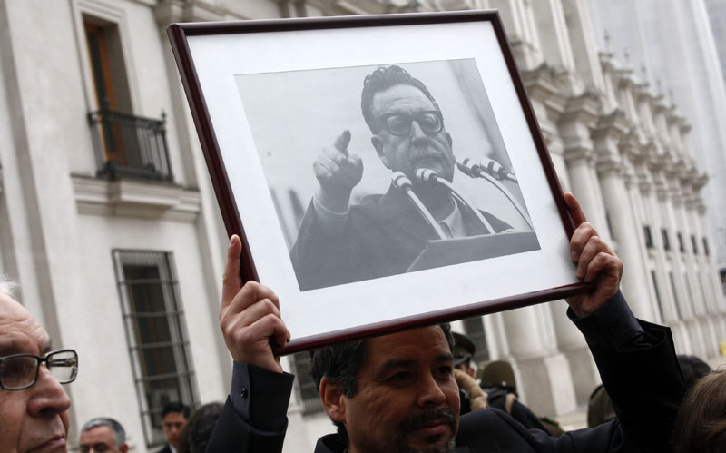 CH17. SANTIAGO DE CHILE (CHILE), 11/09/2013. Un hombre sostiene una fotografía del difunto Salvador Allende hoy, miércoles 11 de septiembre de 2013, durante los actos por el 40 aniversario del golpe de Estado en Santiago de Chile (Chile). La conmemoración del golpe se vivirá hoy con una multitud de actos, que incluyen una visita a su tumba en el Cementerio General de Santiago y una velatón (encendido de velas) en el Estadio Nacional, que funcionó como centro de detención y torturas. EFE/Felipe Trueba