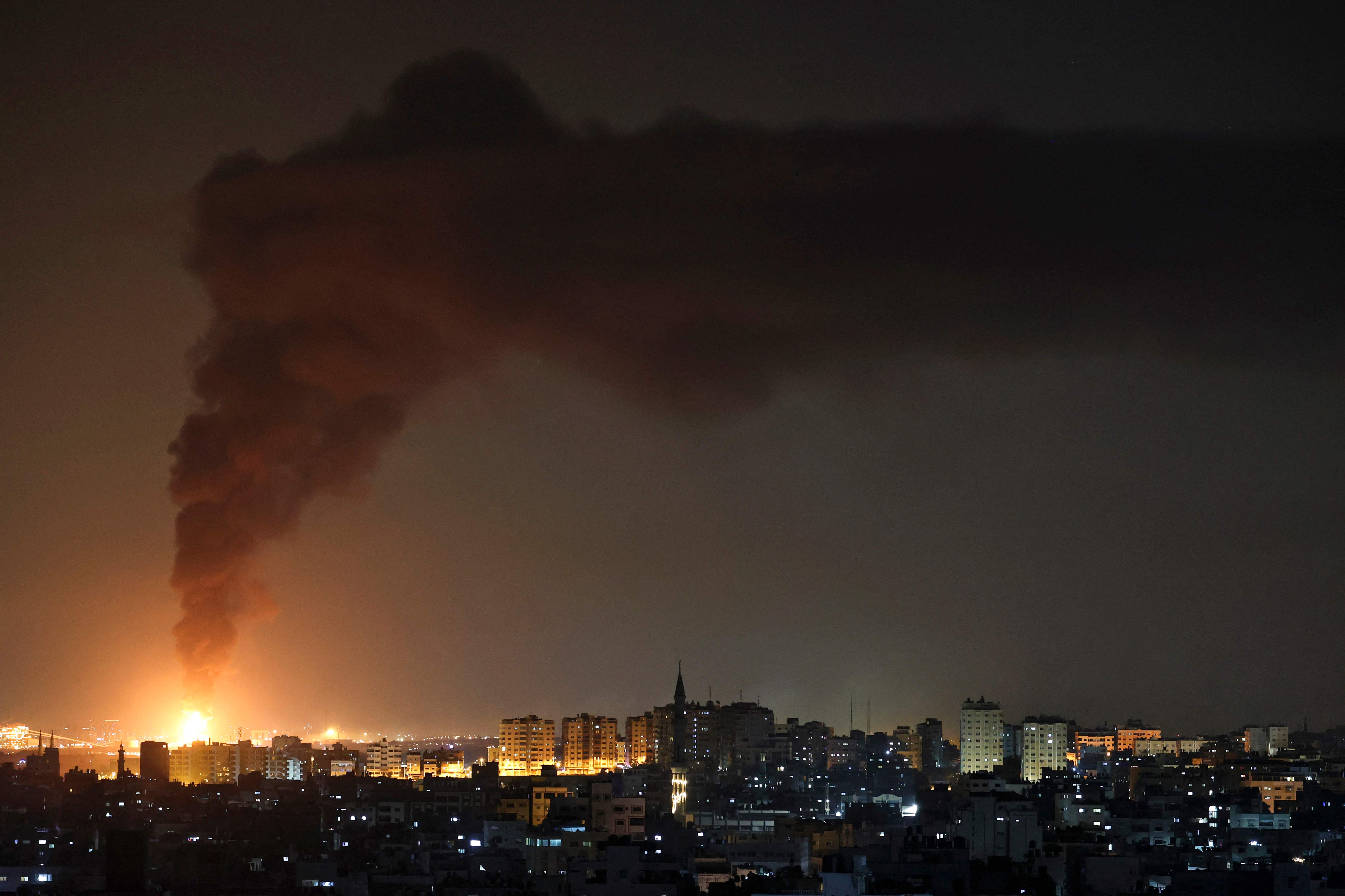 A huge column of smoke seen from Gaza city billows from an oil facility in the southern Israeli city of Ashkelon, on May 11, 2021, after rockets were fired by the Palestinian Hamas movement from the Gaza Strip towards Israel. (Photo by MOHAMMED ABED / AFP)