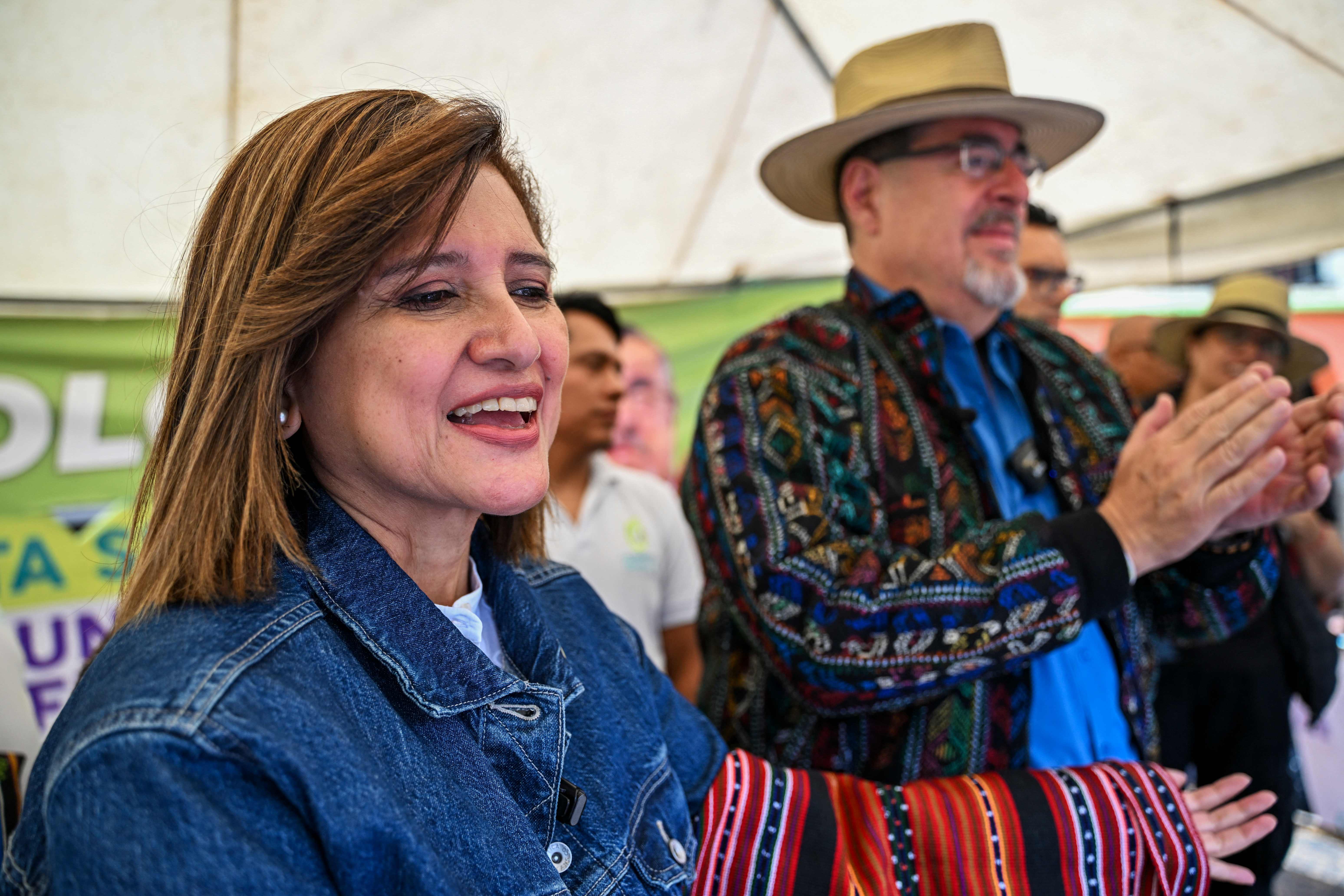 Guatemalan presidential candidate for the Movimiento Semilla party, Bernardo Arevalo (R), and his running mate Karin Herrera (L) gesture during the launch of their campaign for the runoff election in Solola, Guatemala on July 14, 2023. The Guatemalan Attorney General's Office announced this Friday that it will continue the criminal investigation against the Semilla party of the social democratic candidate Bernardo Arevalo for alleged irregularities in its registration, although without affecting the August runoff election. (Photo by Johan ORDONEZ / AFP)