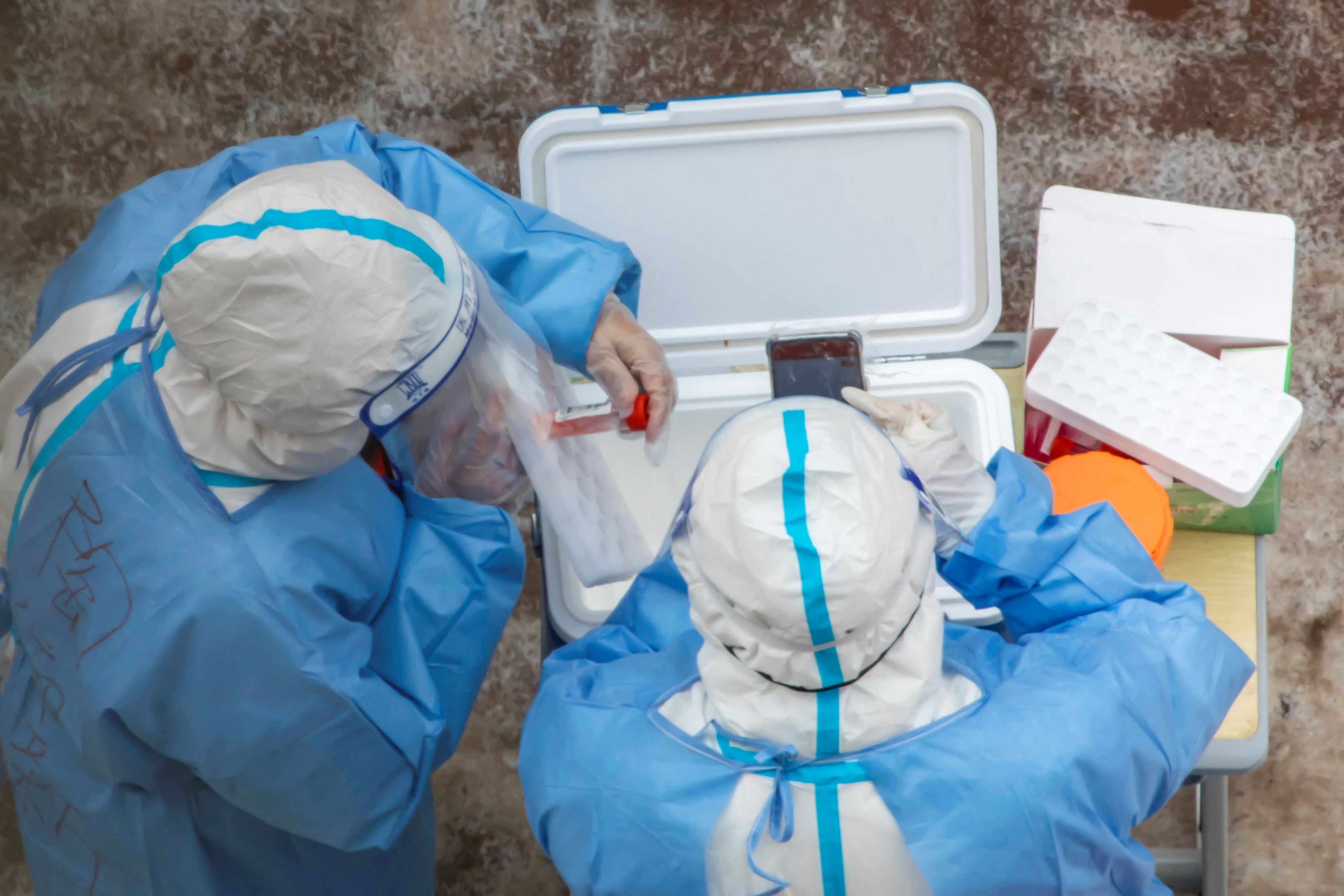 Medical workers collect samples that will be tested for the Covid-19 coronavirus in Jilin in China's northeastern Jilin province on March 15, 2022. (Photo by AFP) / China OUT