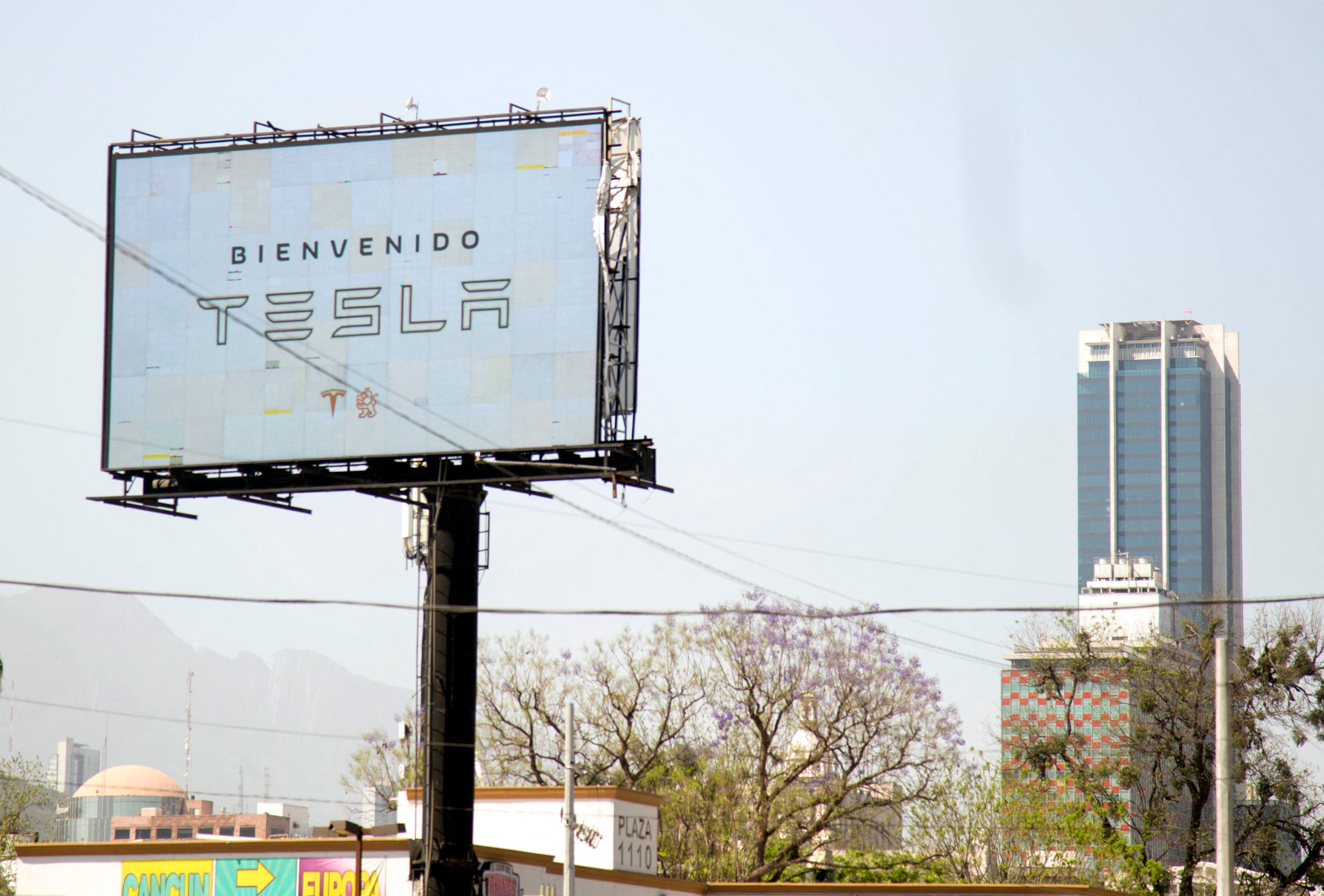 A billboard welcoming the American electric car maker Tesla is seen in Monterrey, state of Nuevo Leon, Mexico, on March 12, 2023. - Monterrey has positioned itself as one of the cities with the highest economic investment in different areas, with billionaire Elon Musk recently confirming his Tesla company's plans to build a new electric car factory in the city. (Photo by Julio Cesar AGUILAR / AFP)