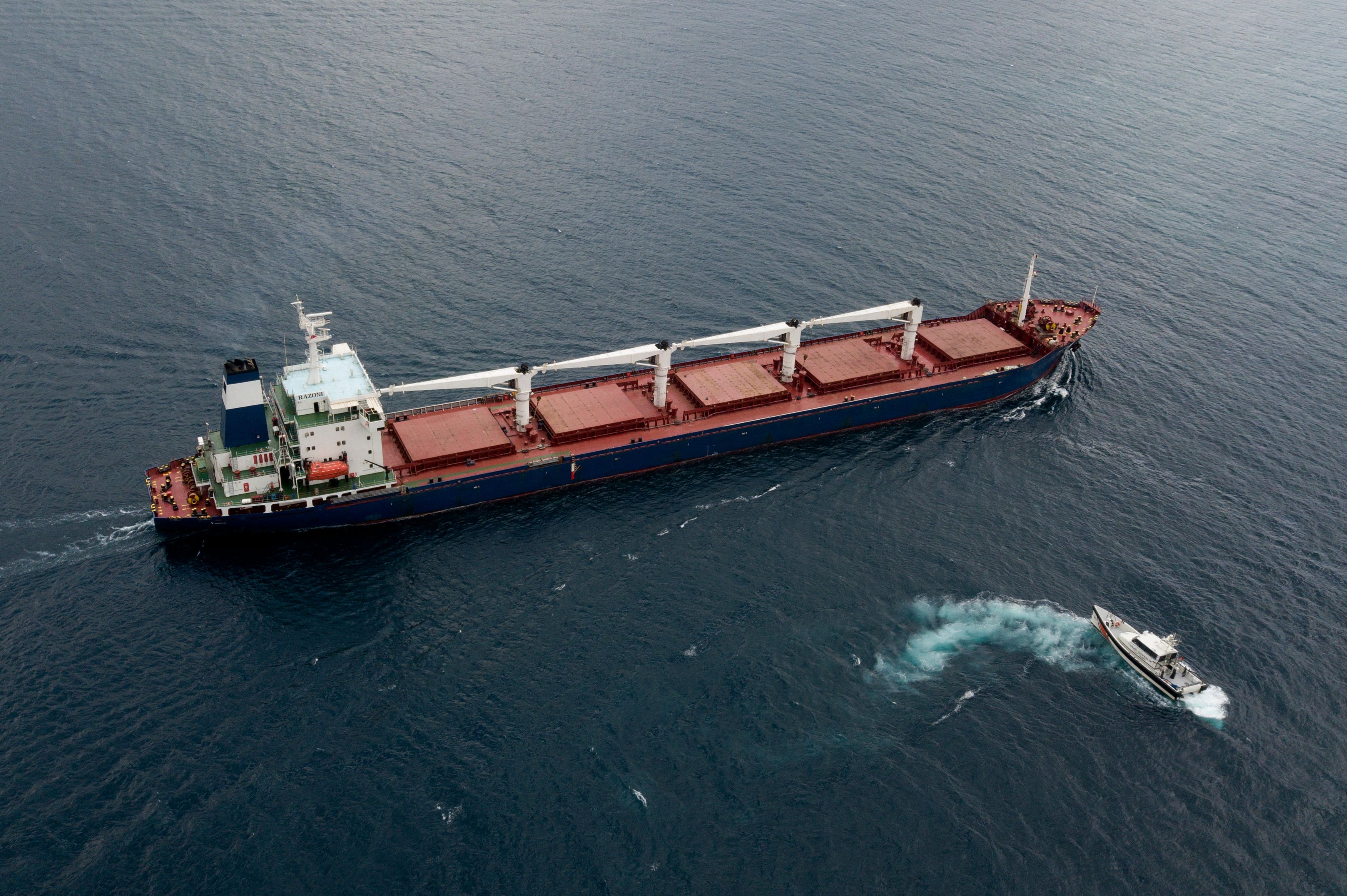 An aerial view shows the Sierra Leone-flagged cargo vessel Razoni sailing en route to Tripoli, Lebanon, along the Bosphorus Strait on August 3, 2022, after being officially inspected. - A team of Russian and Ukrainian officials in Turkey on August 3, 2022, inspected the first shipment of grain exported from Ukraine since Moscow's invasion under a deal aimed at curbing a global food crisis. The Sierra Leone-flagged Razoni arrived at the edge of the Bosphorus Strait just north of Istanbul on August 2, 2022, a day after leaving the Black Sea port of Odessa carrying 26,000 tonnes of maize bound for Lebanon. (Photo by Ozan KOSE / AFP)