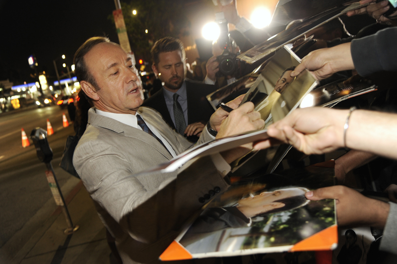 Kevin Spacey signs autographs at a special screening for season 2 of "House of Cards", on Thursday, Feb. 13, 2014 in Los Angeles. (Photo by Chris Pizzello/Invision/AP)