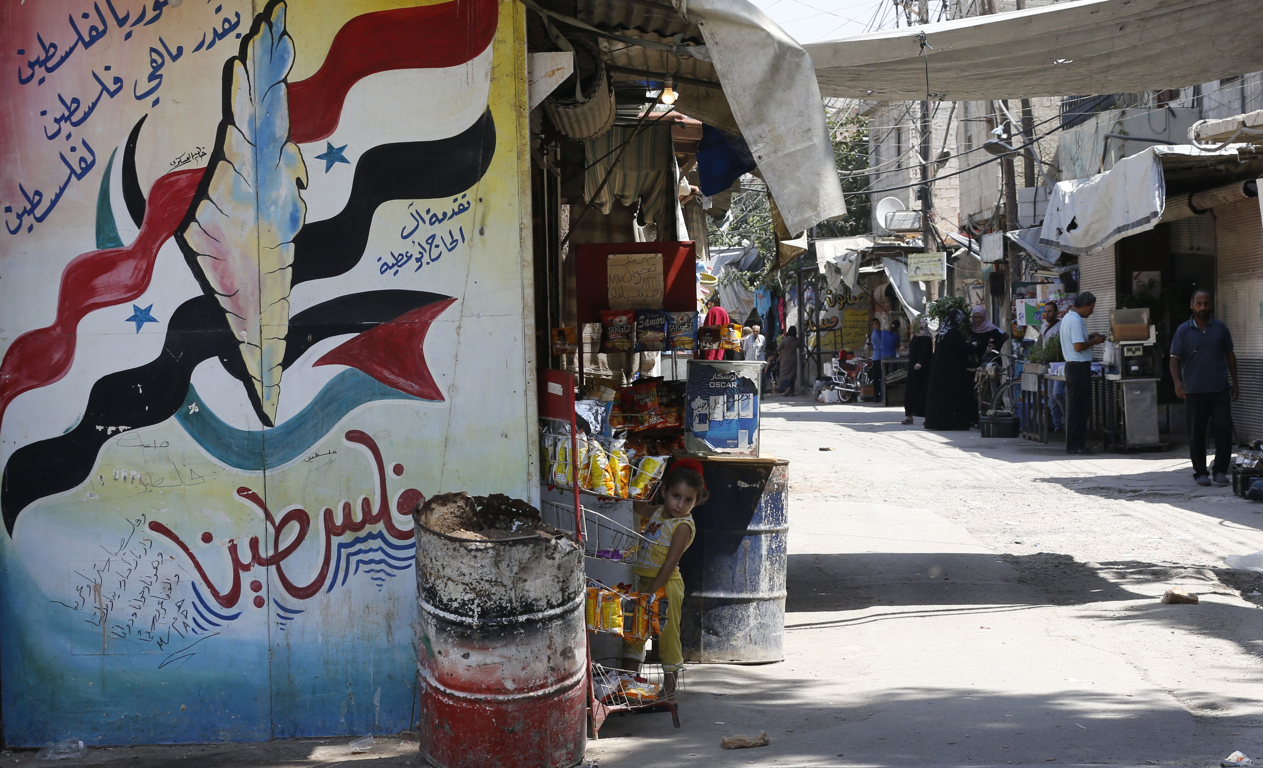 A mural painting about Palestine covers a wall at the Jaramana Palestinian refugee camp in the Syrian capital Damascus on August 2, 2018. - The UN agency for Palestinian refugees (UNRWA) has been a lifeline for millions of Palestinians since it was set up nearly 70 years ago. On August 31, the United States, by far the biggest contributor to the agency, announced it was halting its funding to the organisation, which it labelled "irredeemably flawed". (Photo by LOUAI BESHARA / AFP)