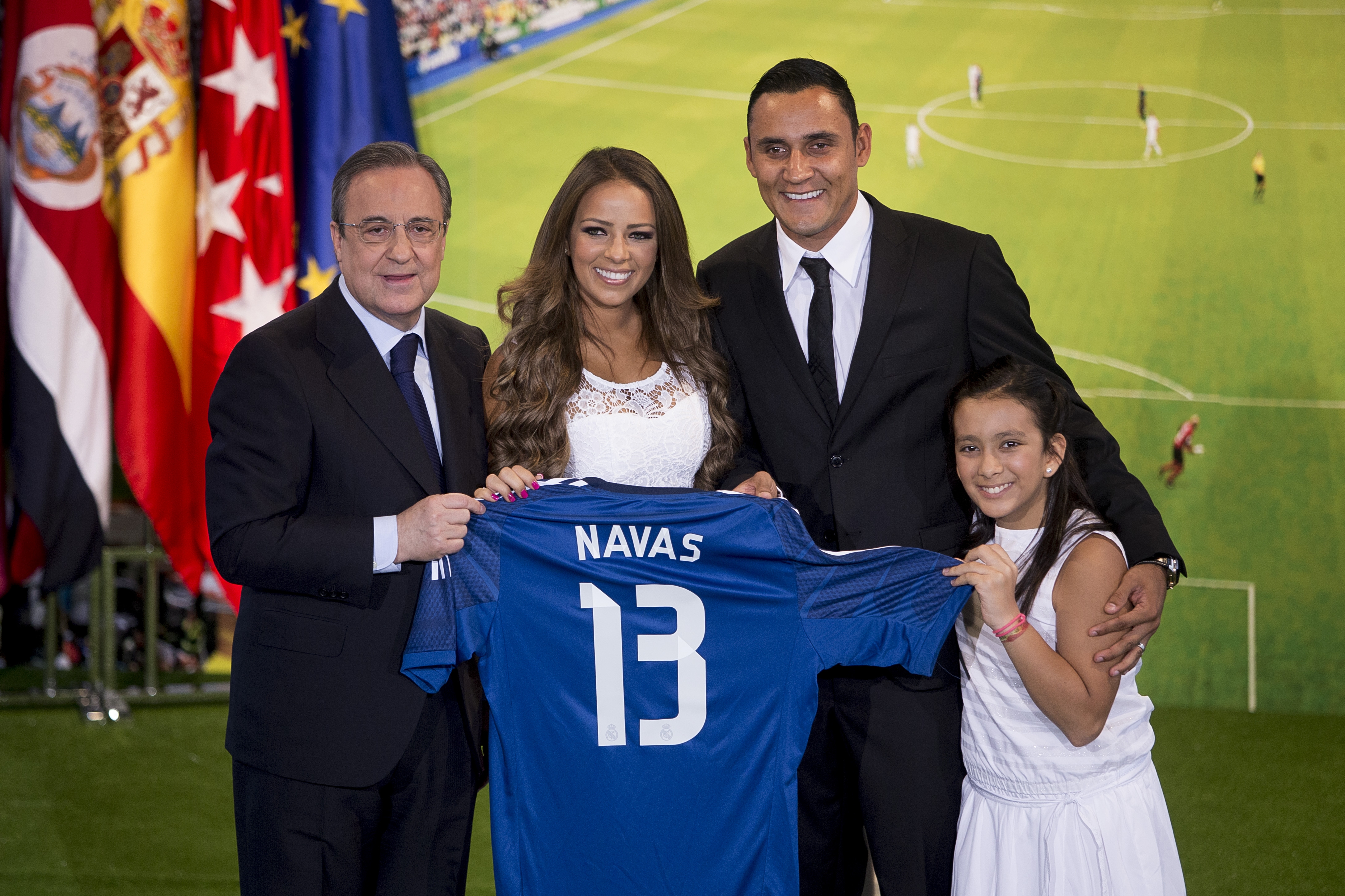 Costa Rica's international goal keeper Keylor Navas, centre right, his wife, Andrea Salas, centre, Real Madrid President Florentino Perez, left, and daughter Daniela, pose during his official presentation at the Santiago Bernabeu stadium in Madrid, Spain, Tuesday, Aug. 5, 2014, after signing for Spanish soccer giants Real Madrid. (AP Photo/Andres Kudacki)