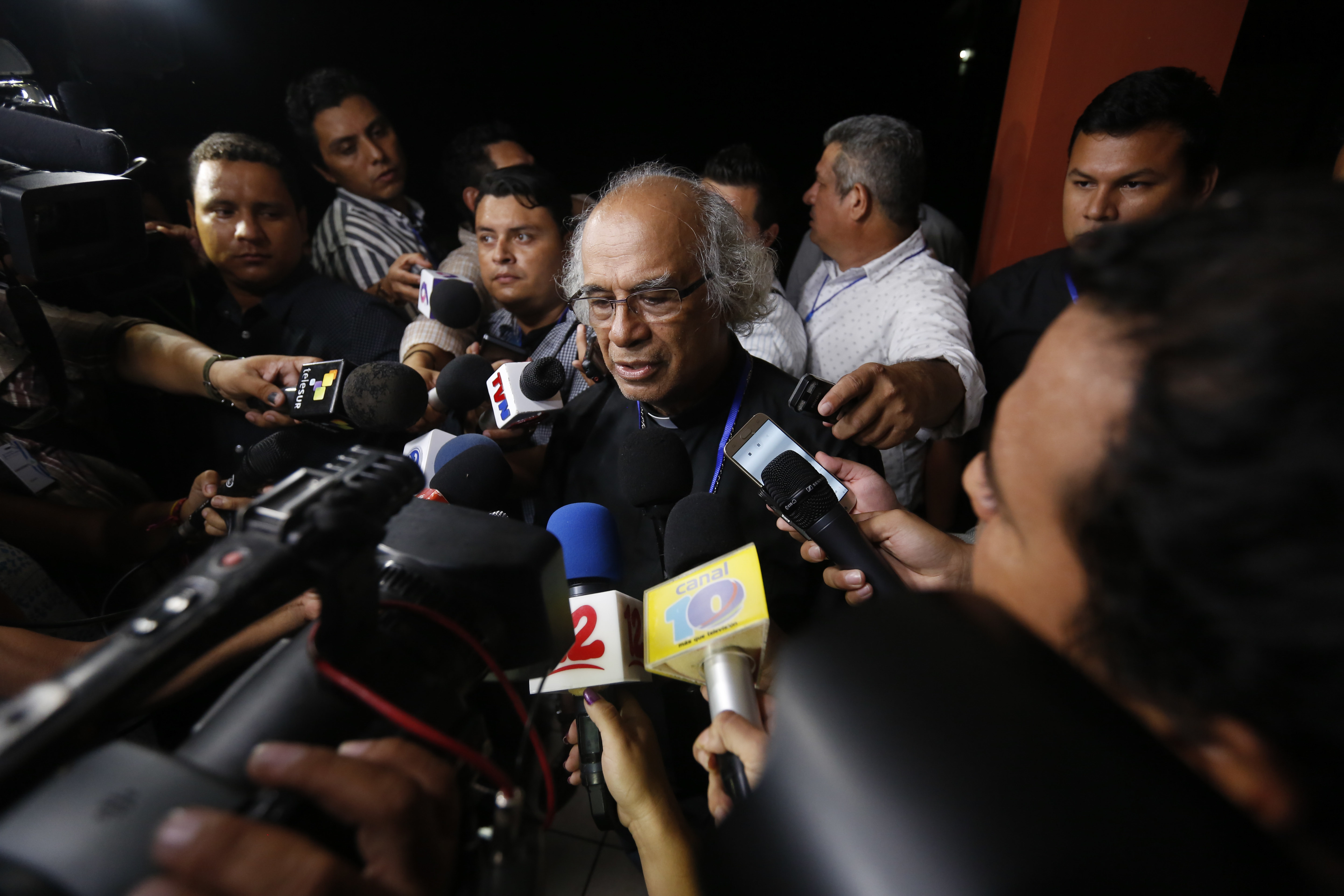 Cardinal Leopoldo Brenes talks with reporters at the end of the third day of the national dialogue in Managua, Nicaragua, Monday, May 21, 2018. The government of Nicaraguan President Daniel Ortega violated human rights through the excessive use of force against street demonstrations, according to the preliminary observations of investigators from the Inter-American Commission on Human Rights. (AP Photo/Alfredo Zuniga)