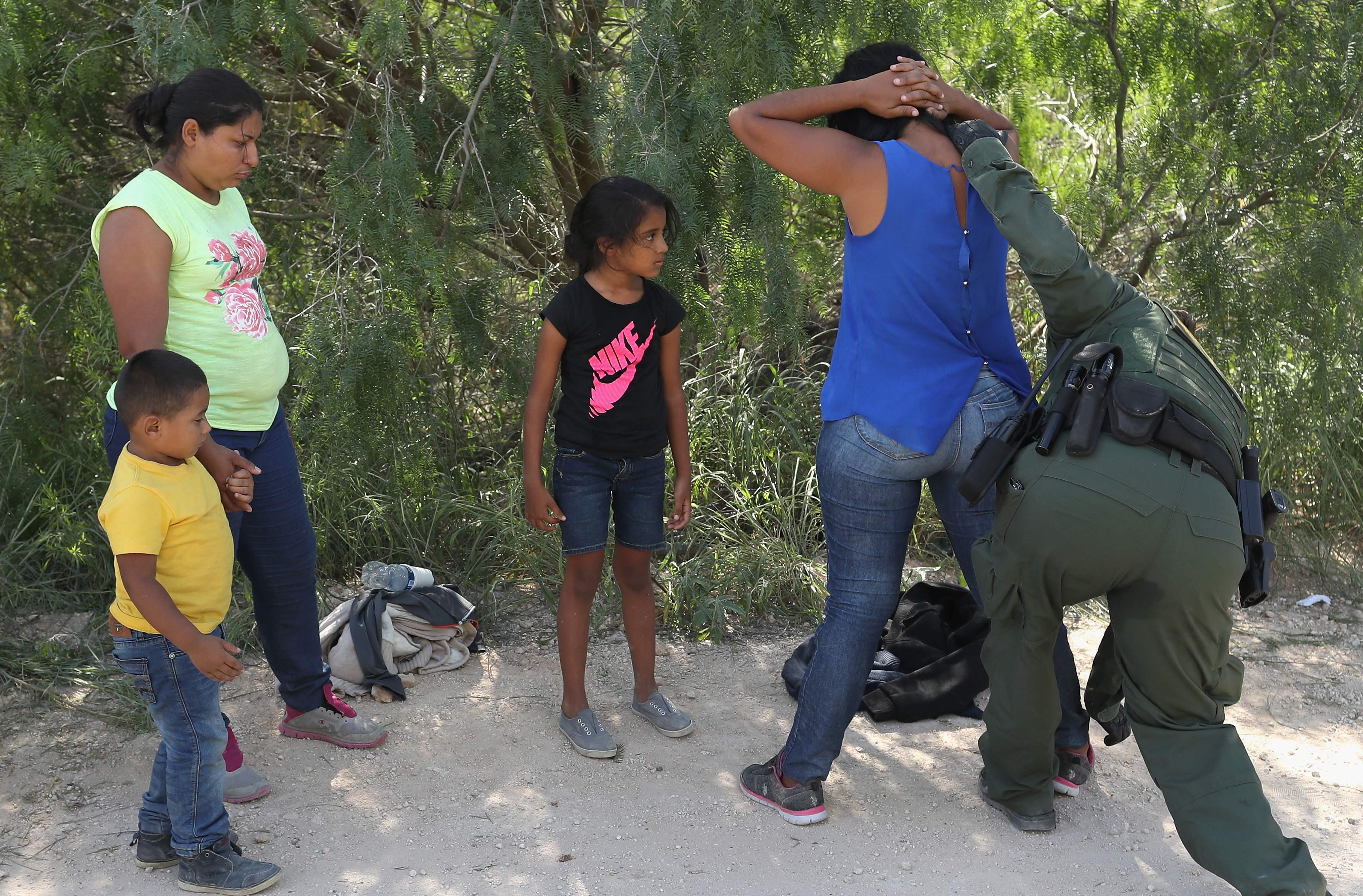 MCALLEN, TX - JUNE 12: Central American asylum seekers are taken into custody by U.S. Border Patrol agents on June 12, 2018 near McAllen, Texas. The families were then sent to a U.S. Customs and Border Protection (CBP) processing center for possible separation. U.S. border authorities are executing the Trump administration's "zero tolerance" policy towards undocumented immigrants. U.S. Attorney General Jeff Sessions also said that domestic and gang violence in immigrants' country of origin would no longer qualify them for political asylum status. John Moore/Getty Images/AFP / AFP PHOTO / GETTY IMAGES NORTH AMERICA / JOHN MOORE