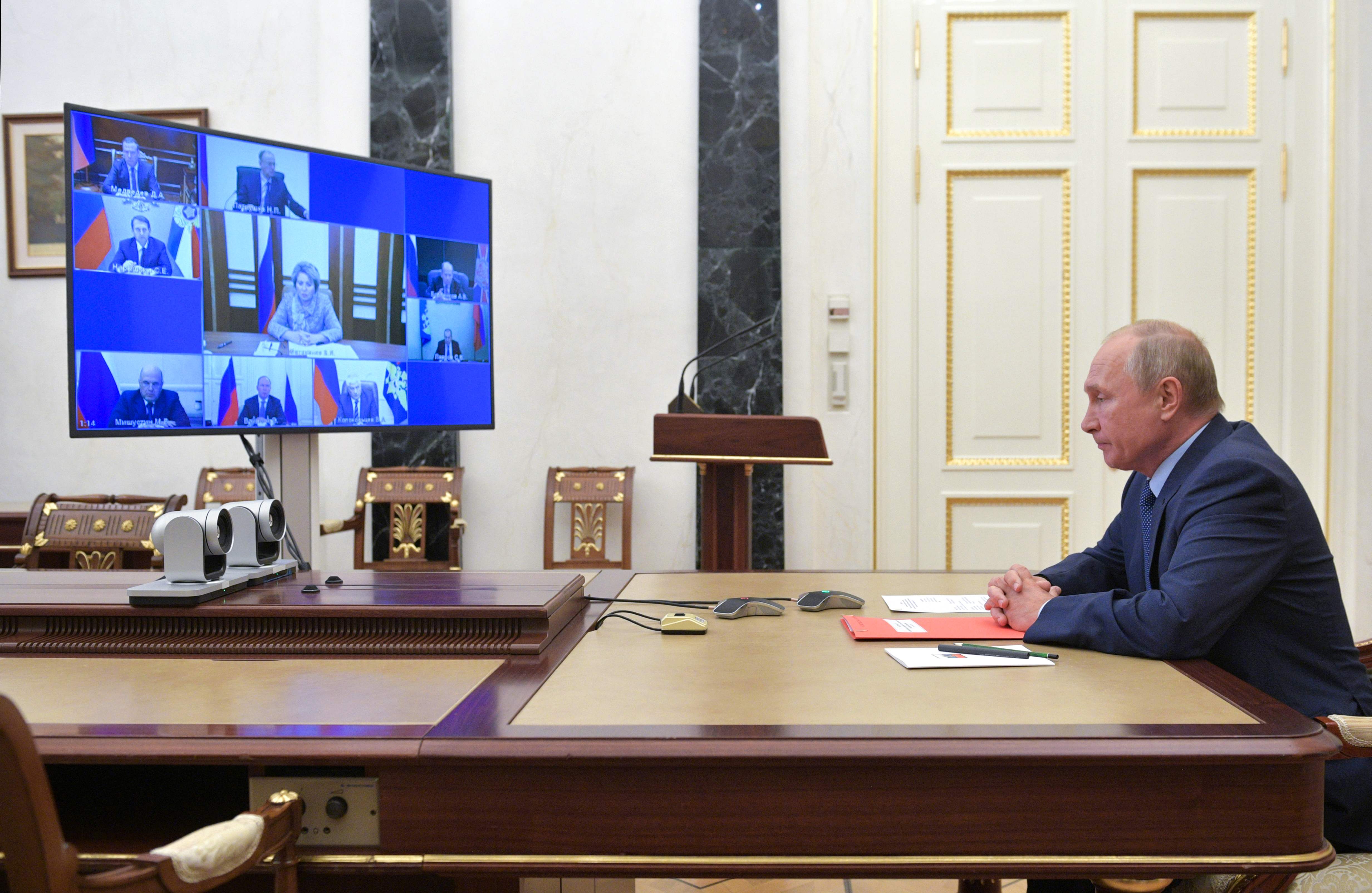 Russian President Vladimir Putin attends a meeting with the members of the Security Council via teleconference call, in Moscow, on October 16, 2020. - Russian President Vladimir Putin proposed on October 16 that Moscow and Washington extend for a year and without any conditions New START, the two nations' last major nuclear arms accord. (Photo by Alexei Druzhinin / Sputnik / AFP)
