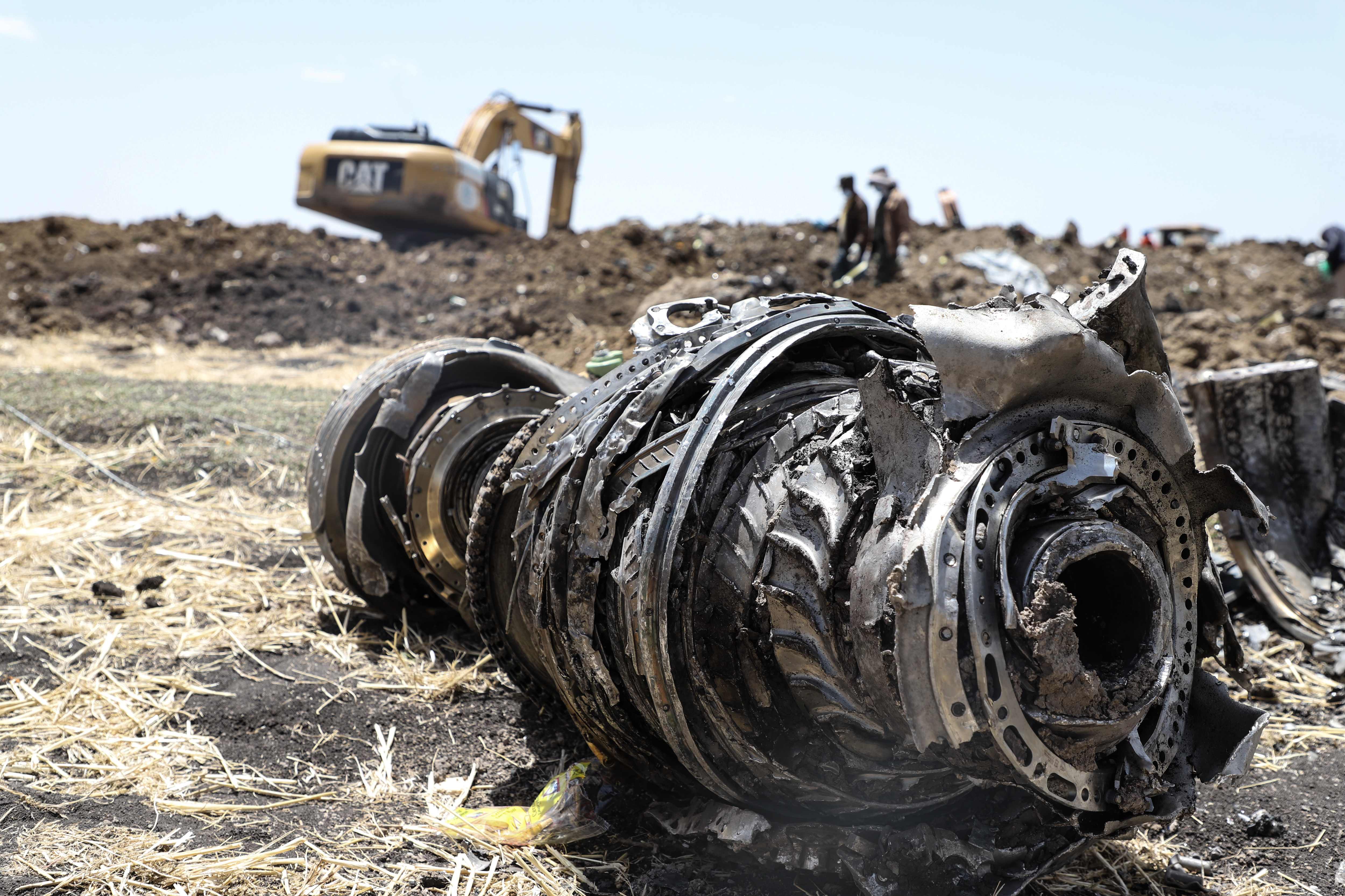 A photo shows debris of the crashed airplane of Ethiopia Airlines, near Bishoftu, a town some 60 kilometres southeast of Addis Ababa, Ethiopia, on March 11, 2019. - Airlines in Ethiopia, China and Indonesia grounded Boeing 737 MAX 8 jets Monday as investigators recovered the black boxes from a brand-new passenger jet that crashed outside Addis Ababa a day earlier, killing all 157 people on board. (Photo by Michael TEWELDE / AFP)