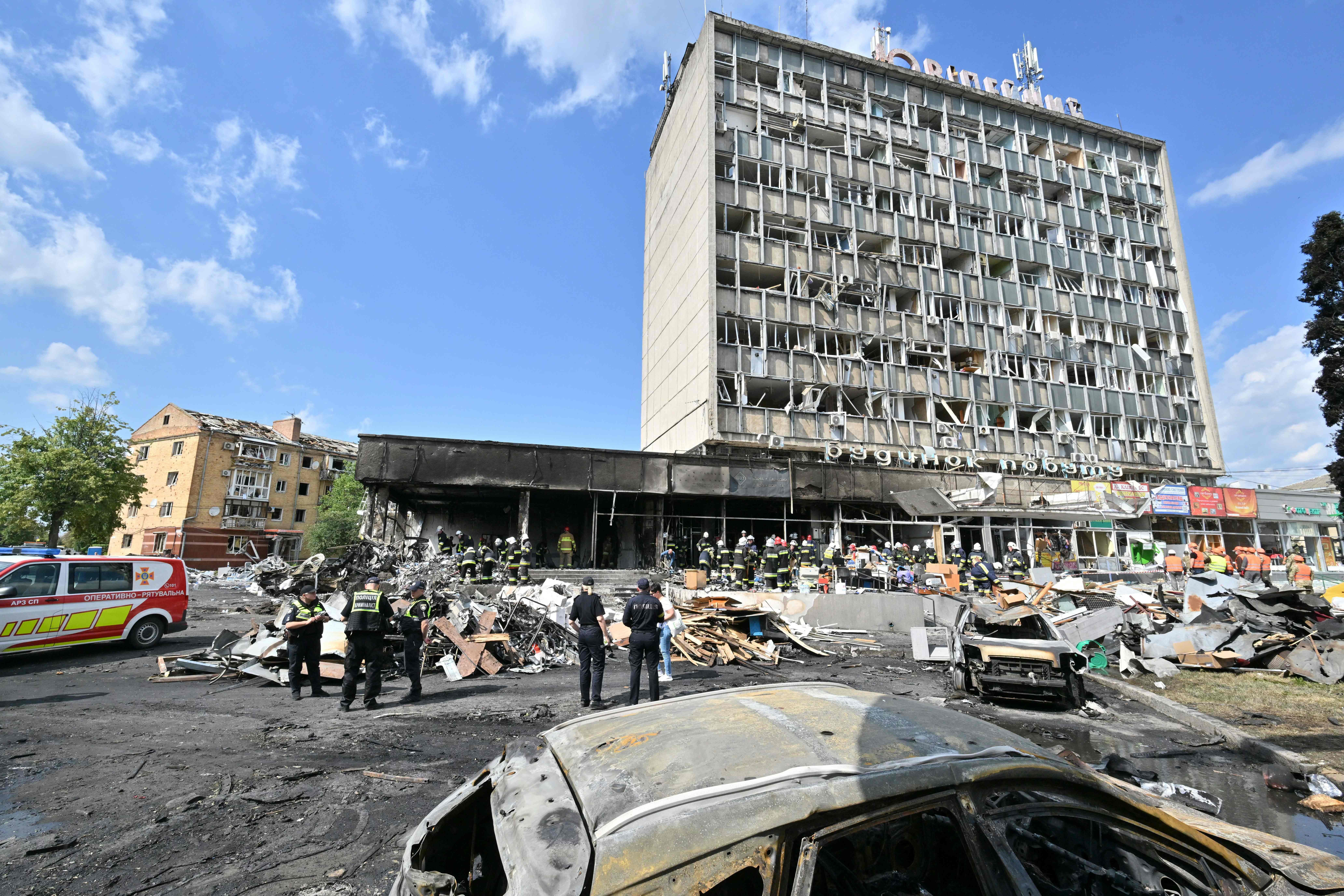 TOPSHOT - Firefighters inspect a damaged building following a Russian airstrike in the city of Vinnytsia, west-central Ukraine on July 14, 2022. - At least 20 people were killed Thursday by Russian strikes on a city in central Ukraine, bombings described as "an openly terrorist act" by Ukrainian President Volodymyr Zelensky. (Photo by Sergei SUPINSKY / AFP)